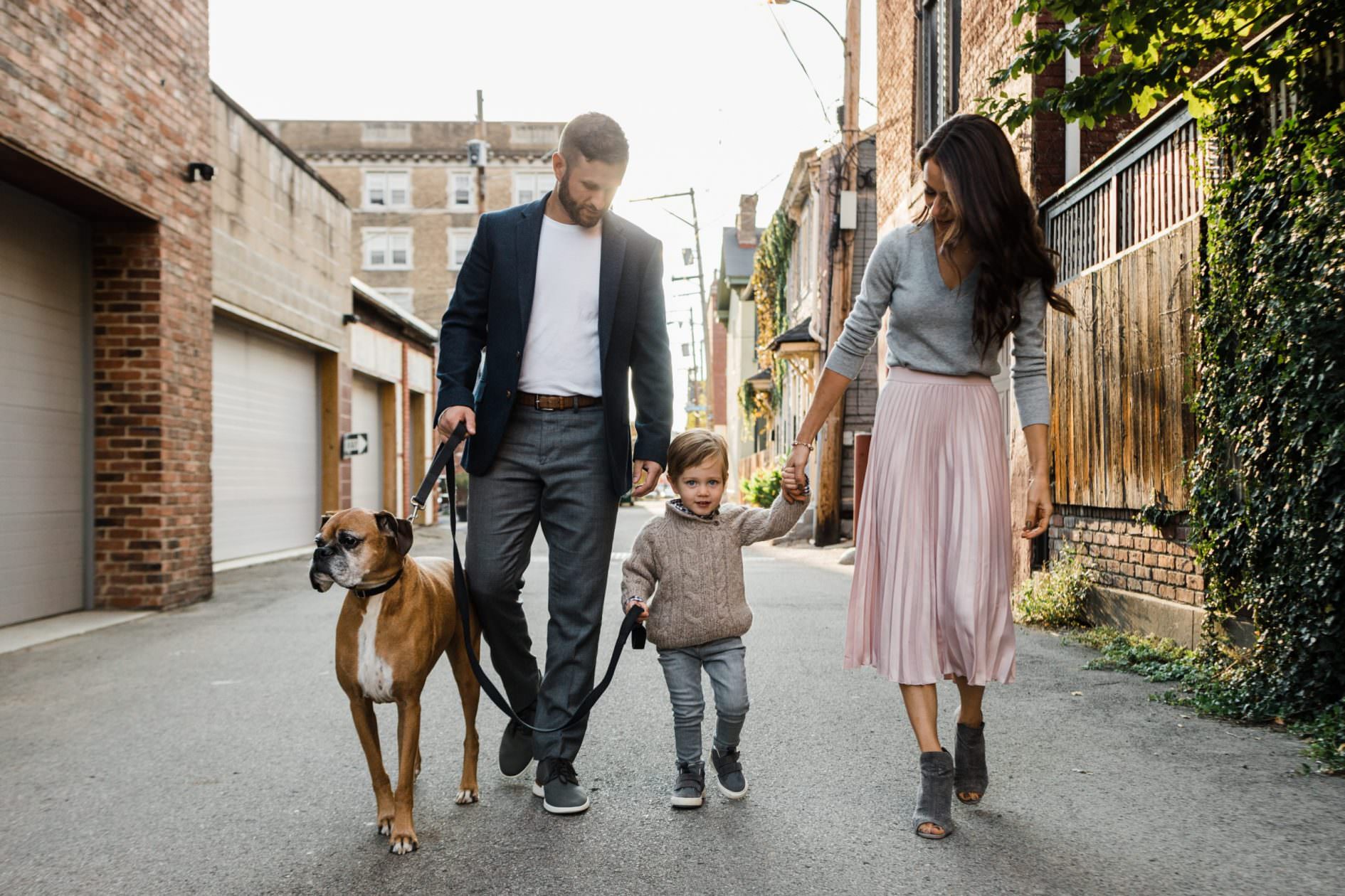 natural family photo in city neighborhood with family dog