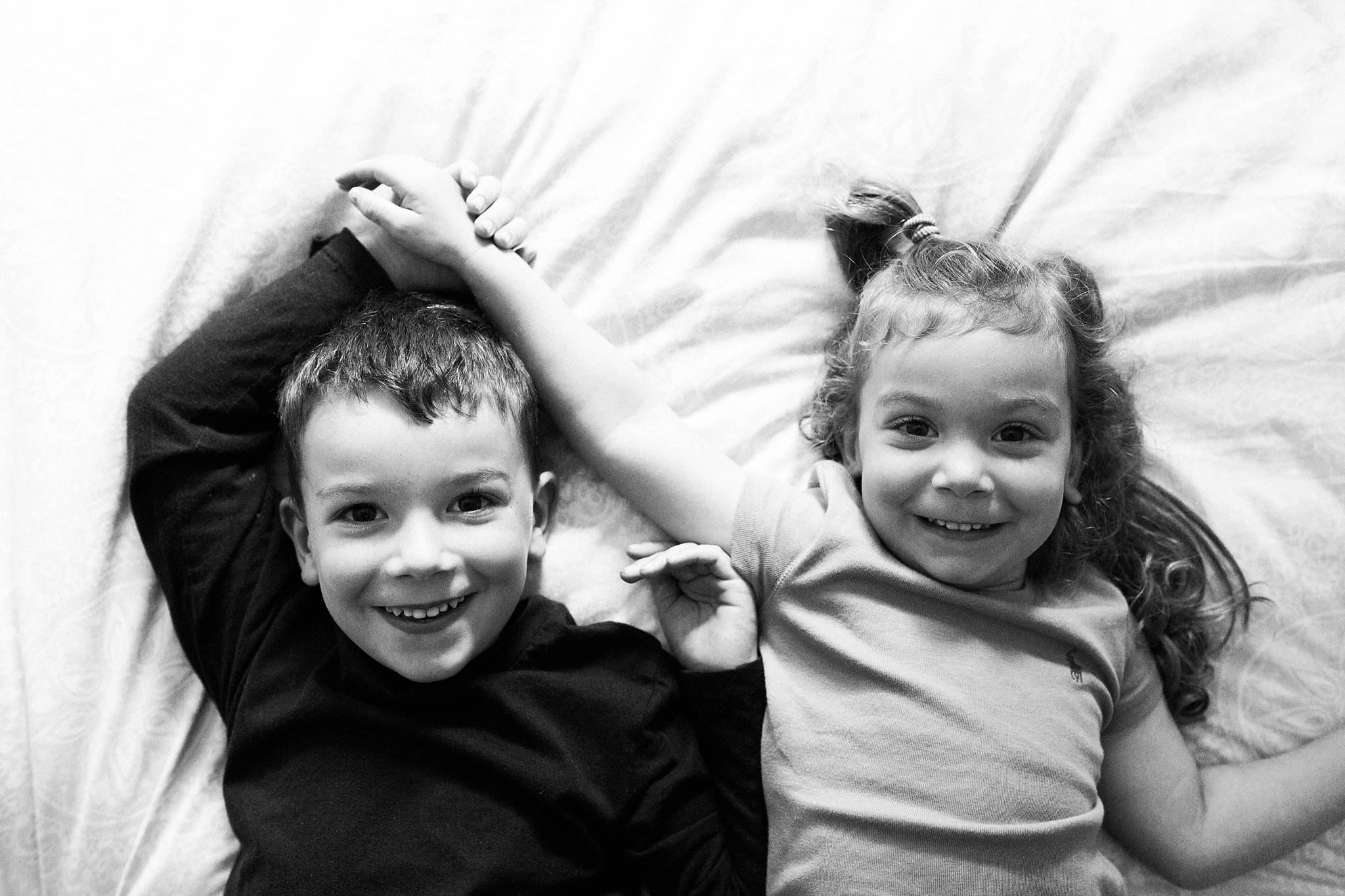 siblings and newborn in home photography