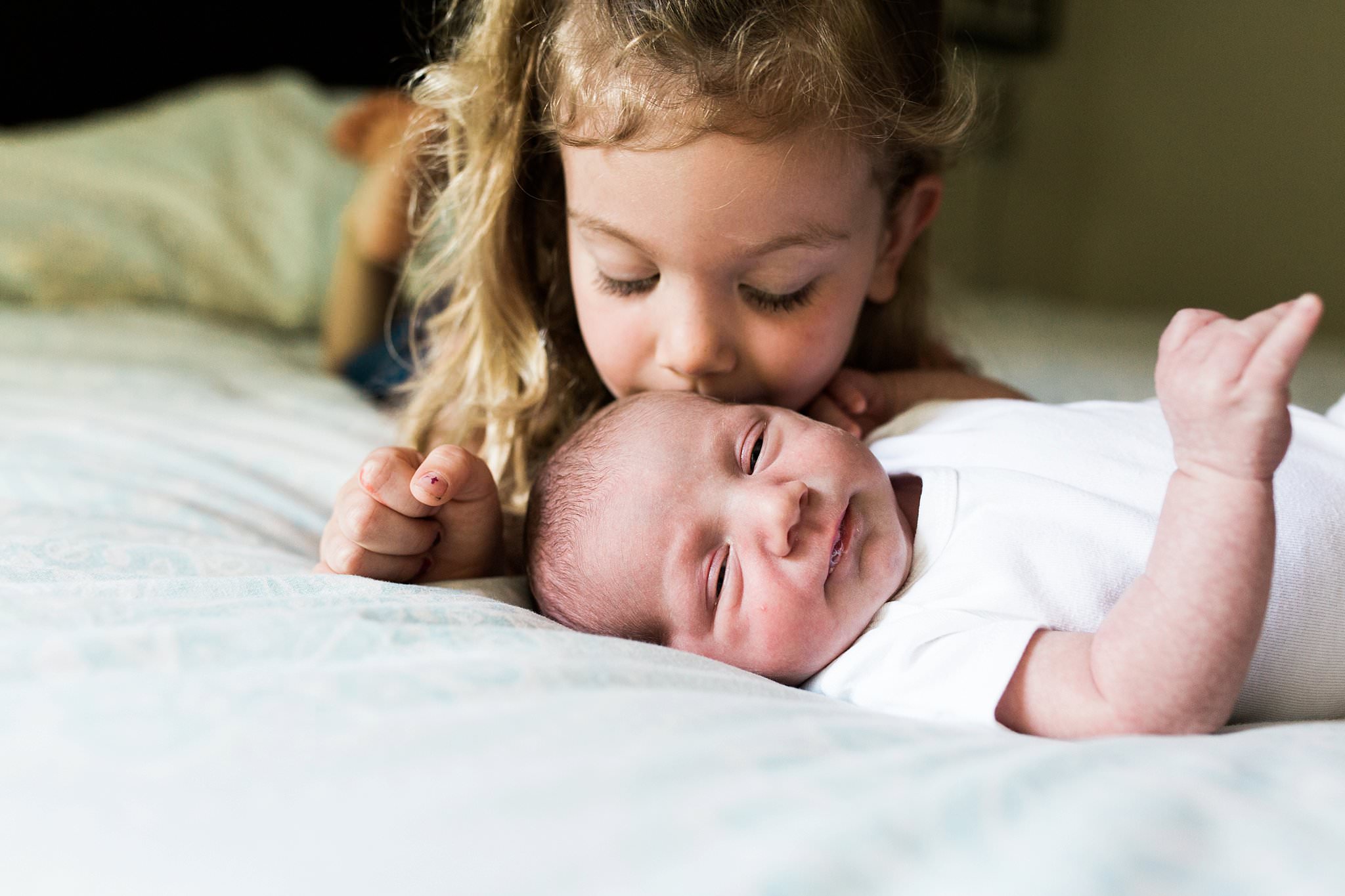siblings and newborn in home photography