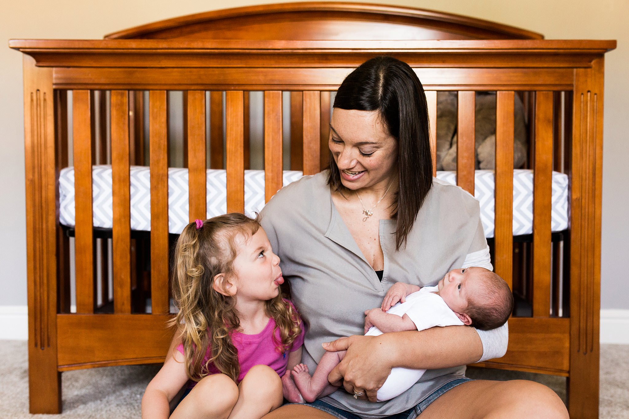 photo of mother with newborn baby and older child