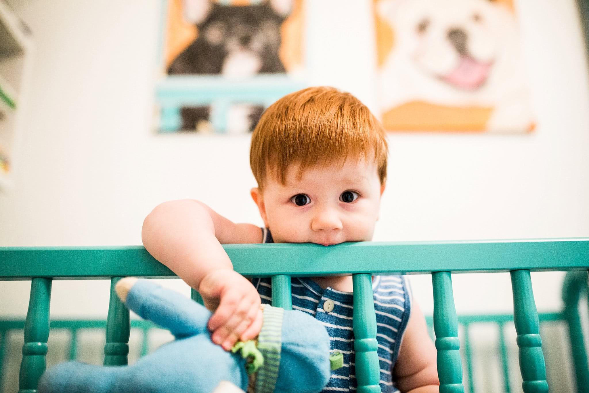 one year old in nursery crib