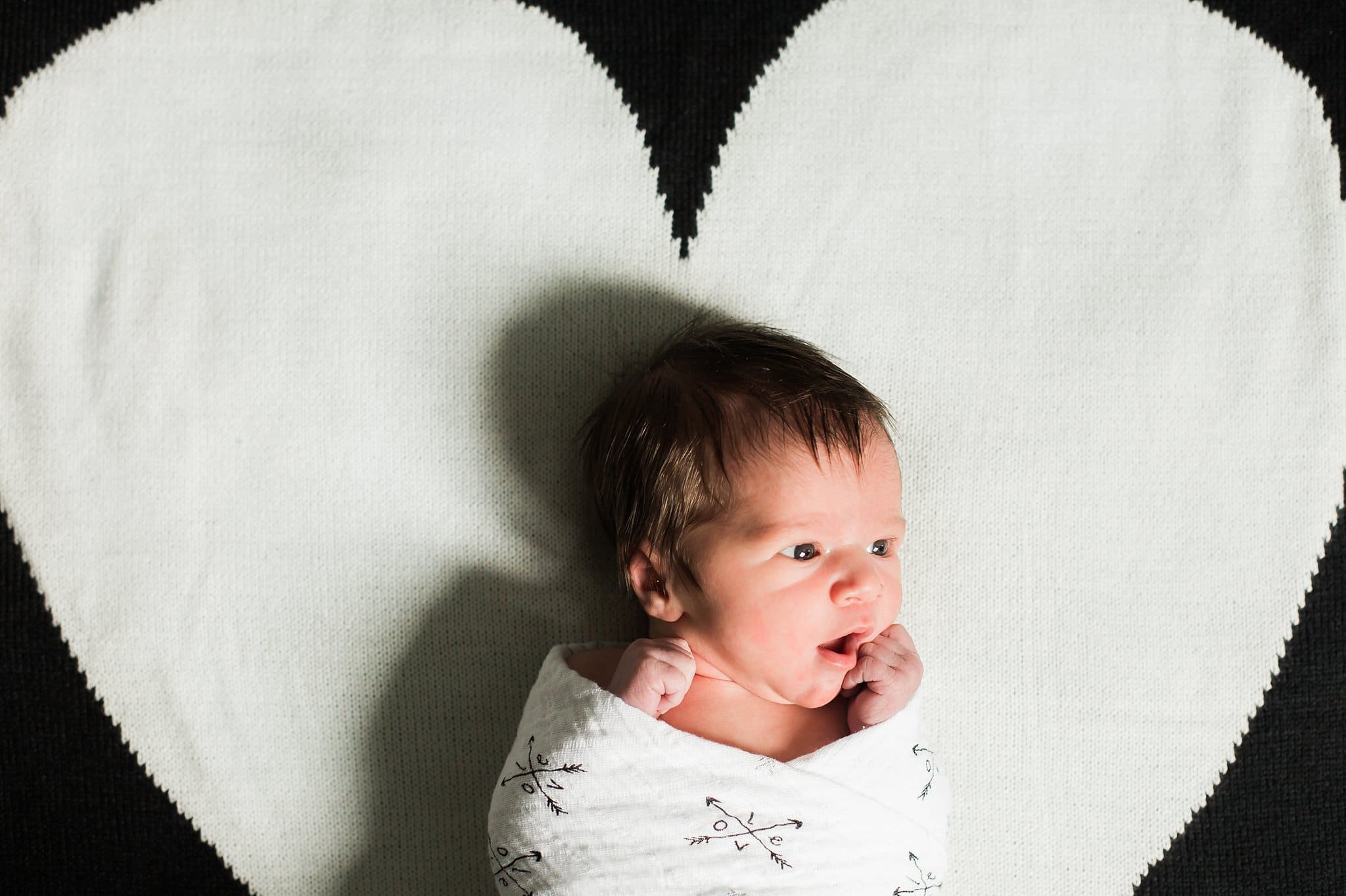 newborn on heart blanket