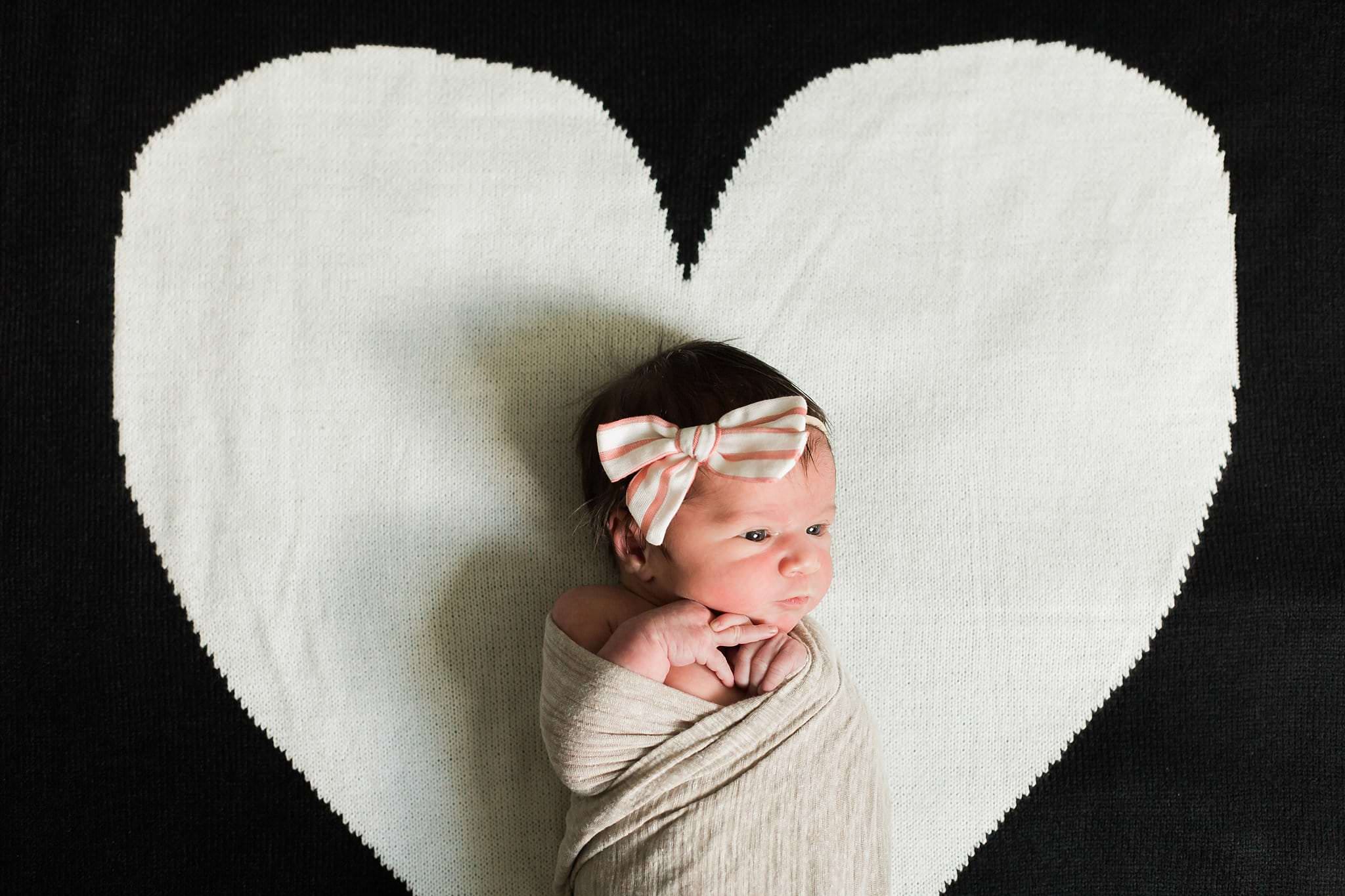 newborn on heart blanket