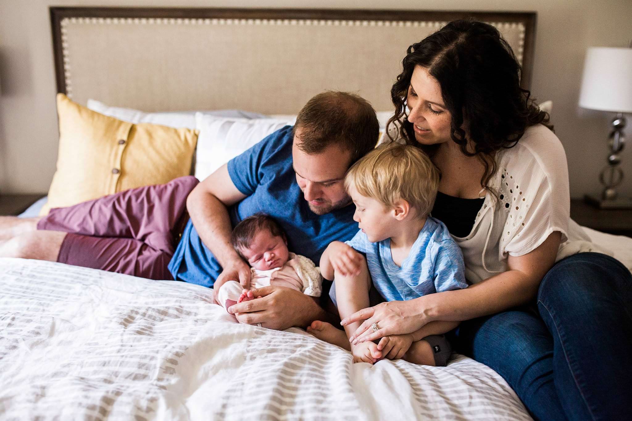 family on bed at in-home newborn session