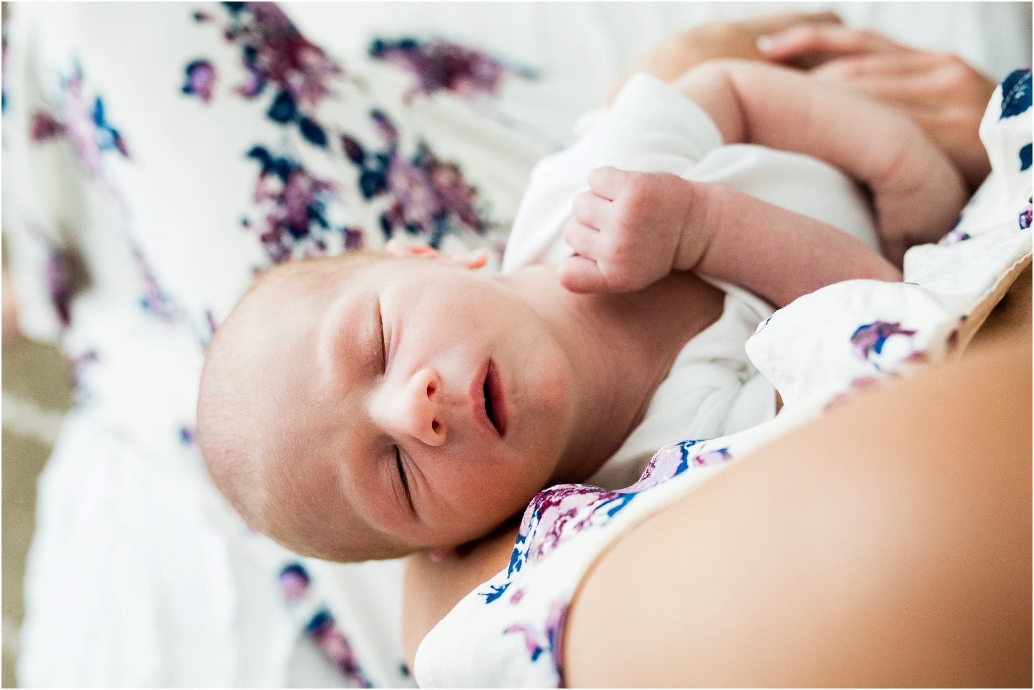 newborn asleep in motherrs arms