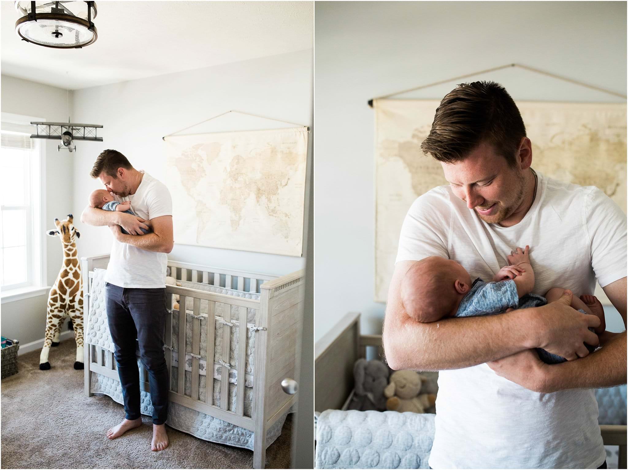 father and newborn son in neutral travel themed nursery