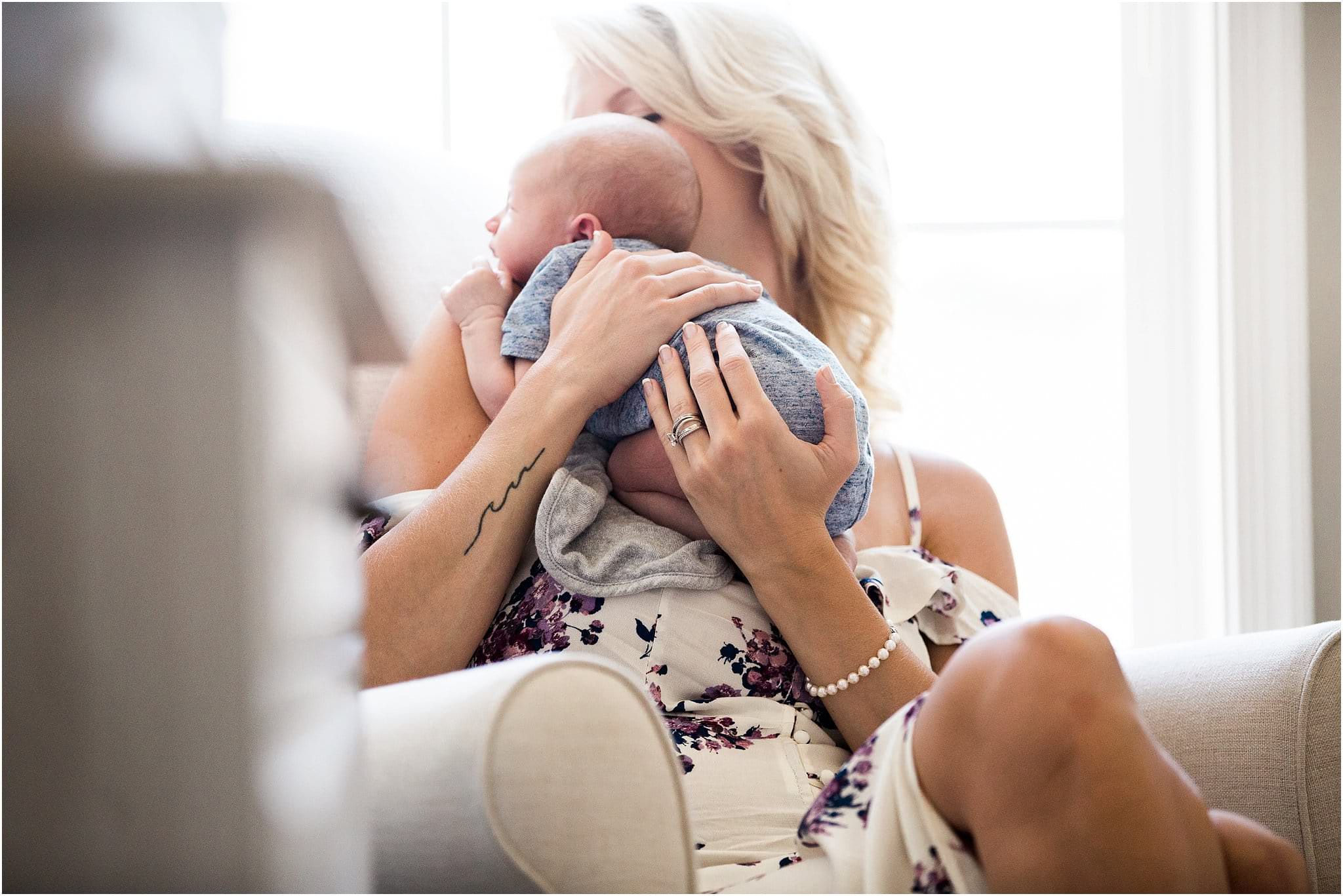 new mom burping newborn baby after nursing