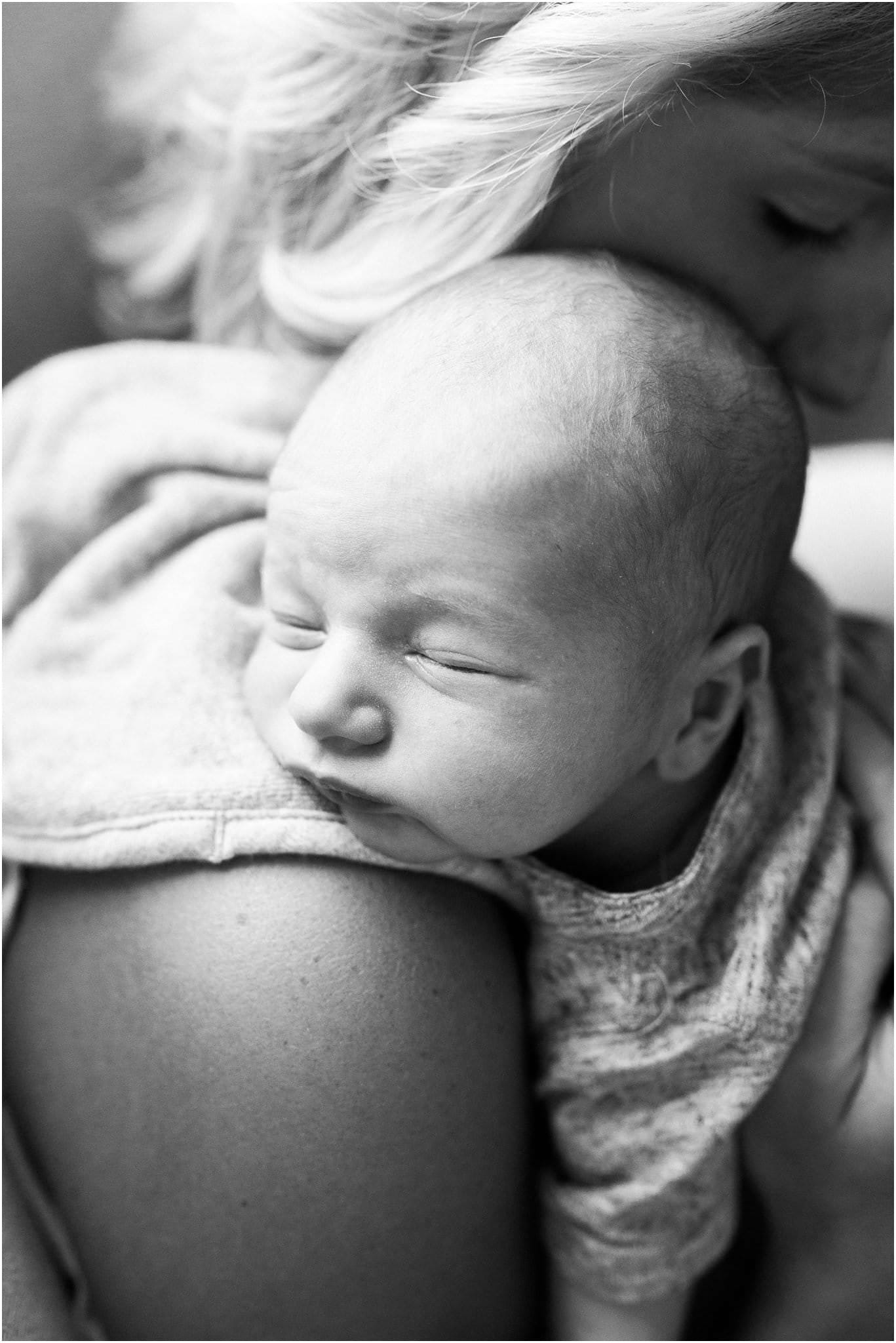newborn baby boy resting on moms shoulder
