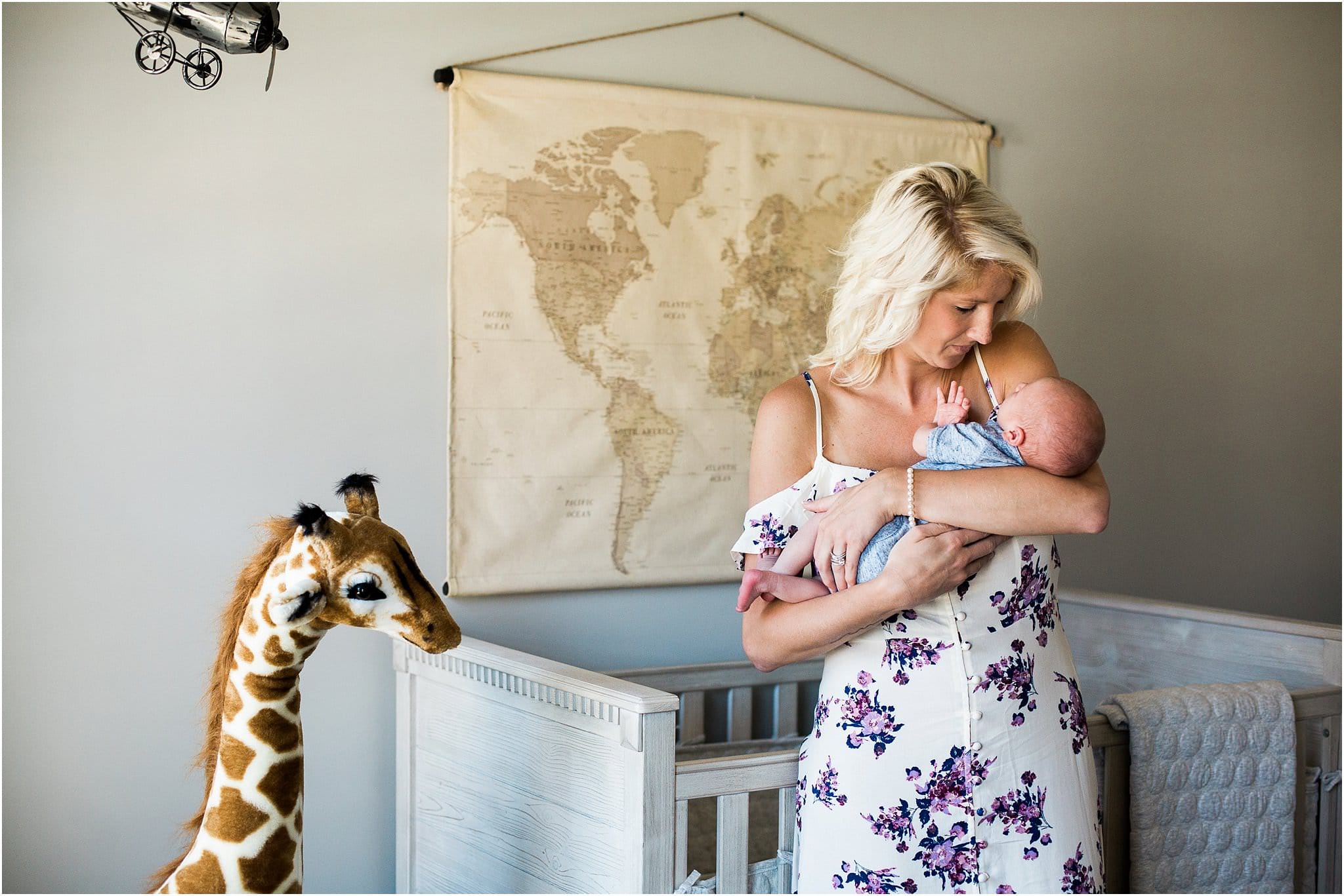 Mother holding newborn boy in nursery