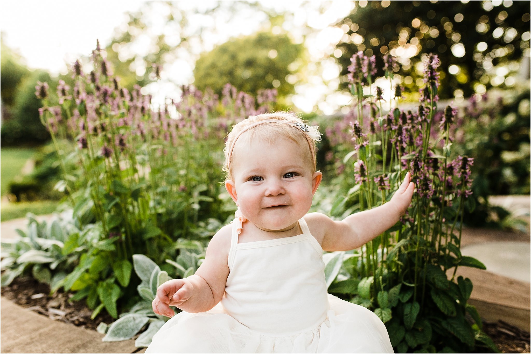 one year old baby girl photo in flowers