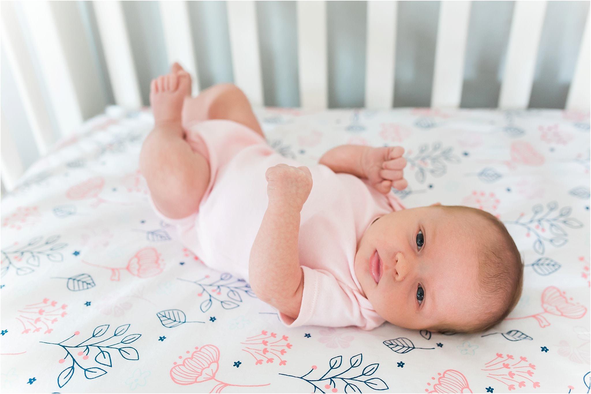 two months old baby girl in crib