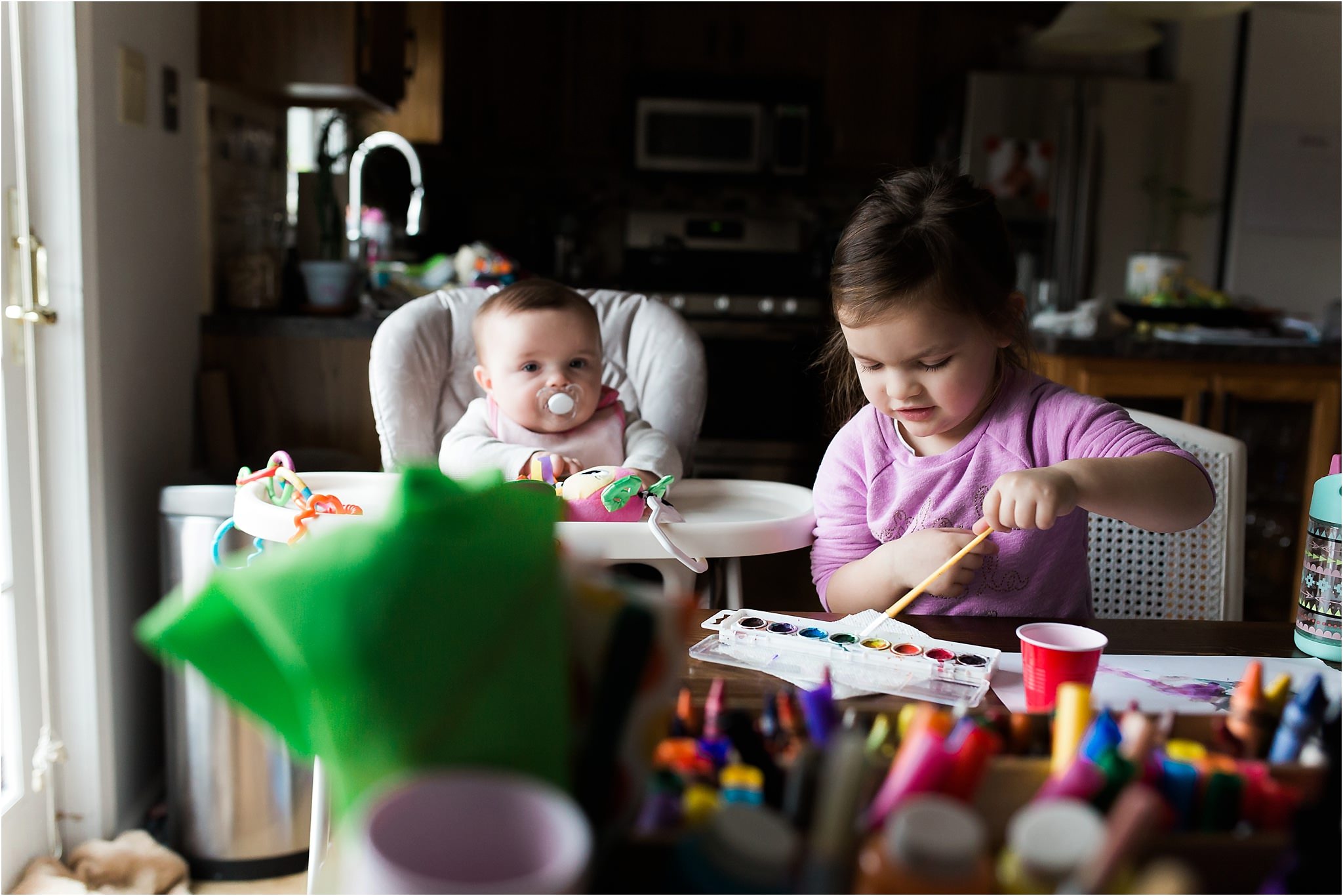 baby and toddler sister doing arts and crafts