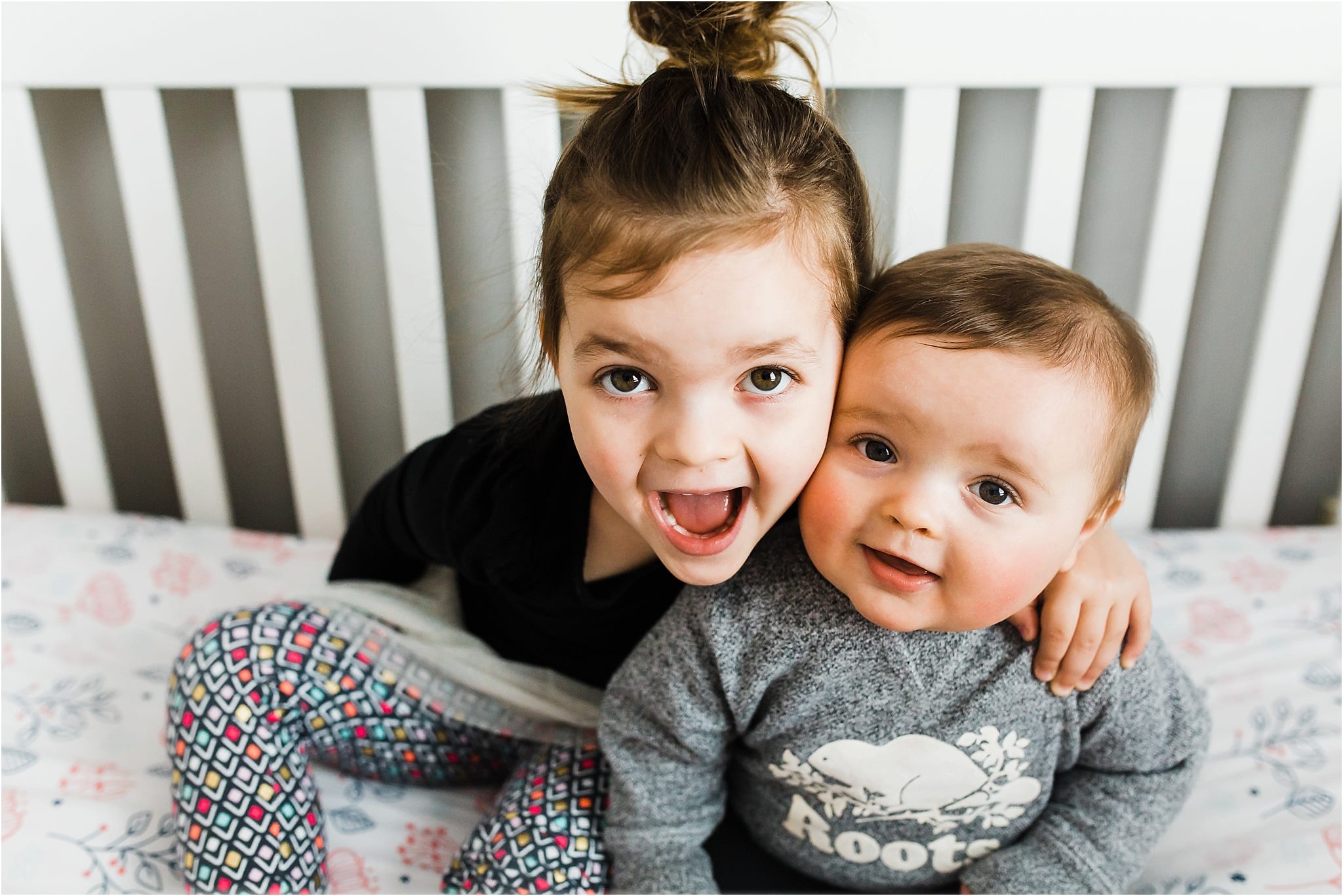 adorable sister in crib smiling