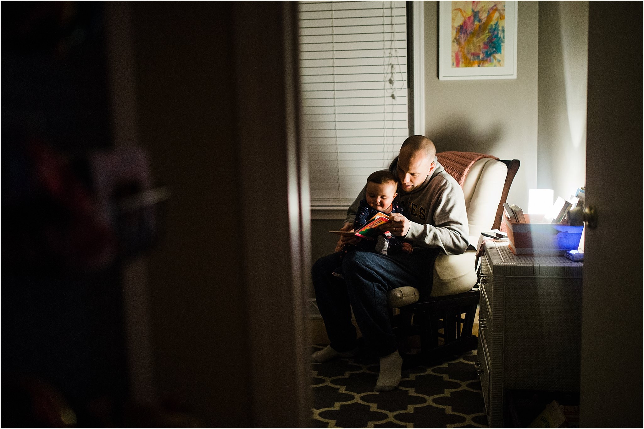 daddy reading to baby girl at bedtime 