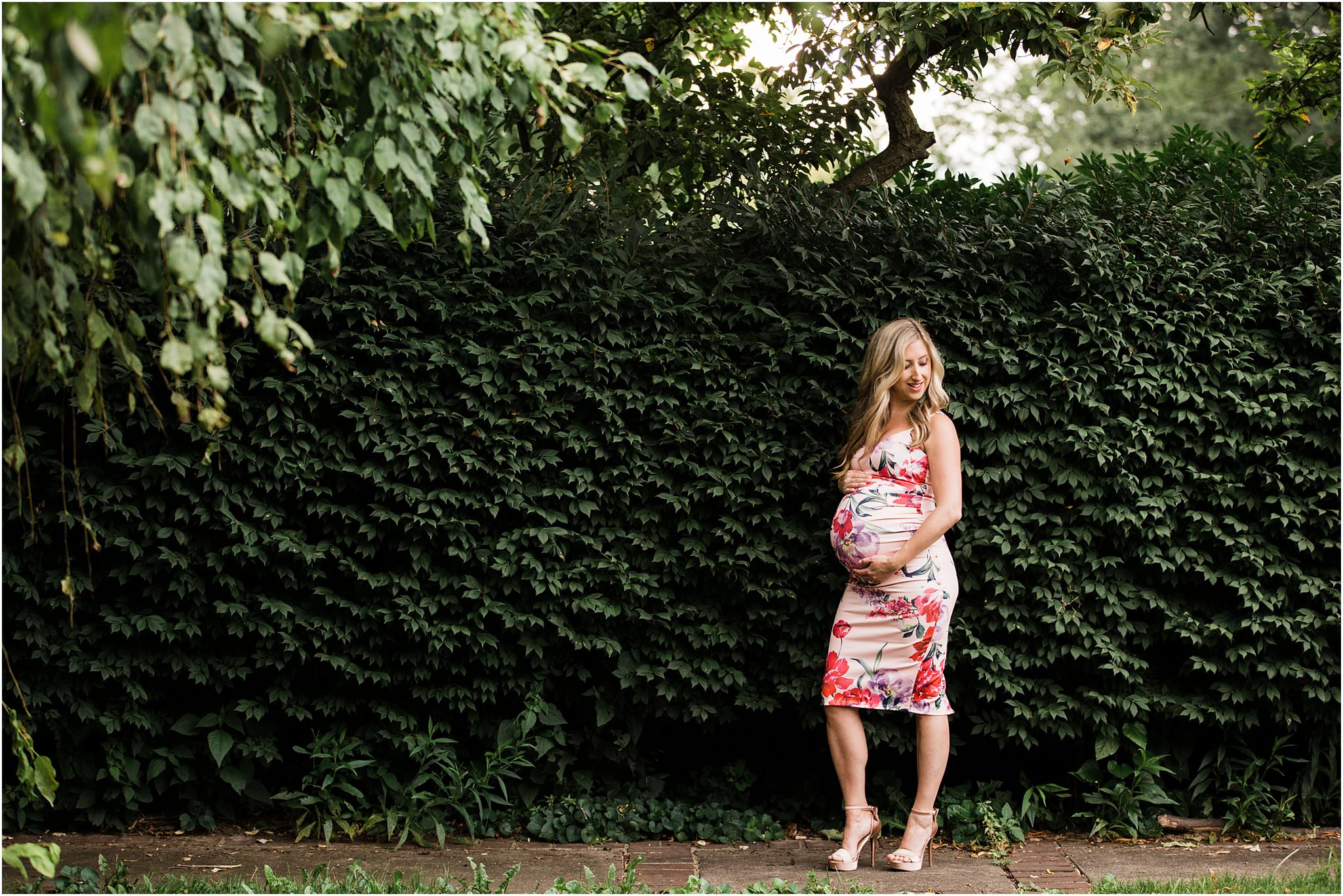 gorgeous mother in form fitting ASOS floral maternity dress