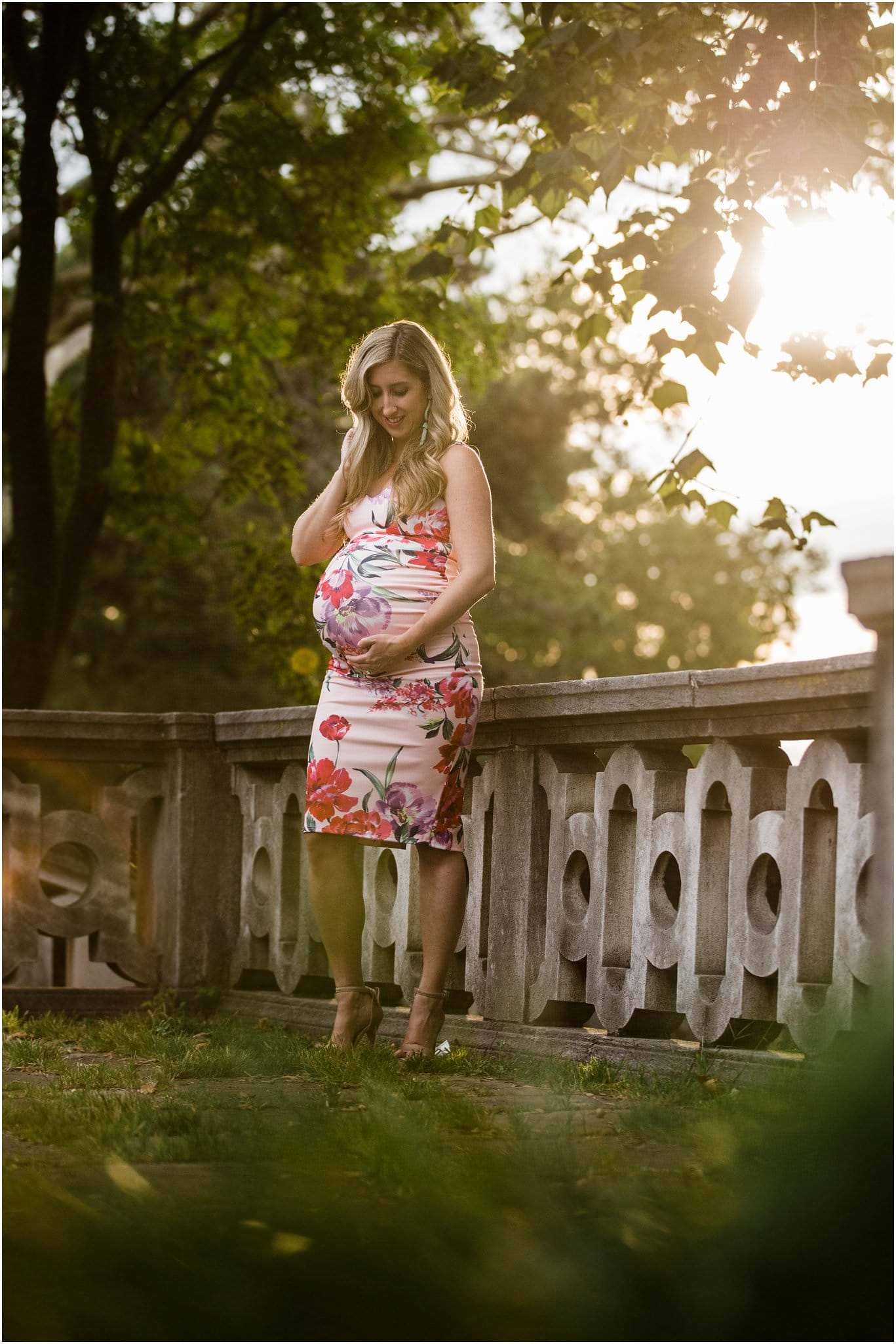 sunset image of gorgeous mother in form fitting ASOS floral maternity dress