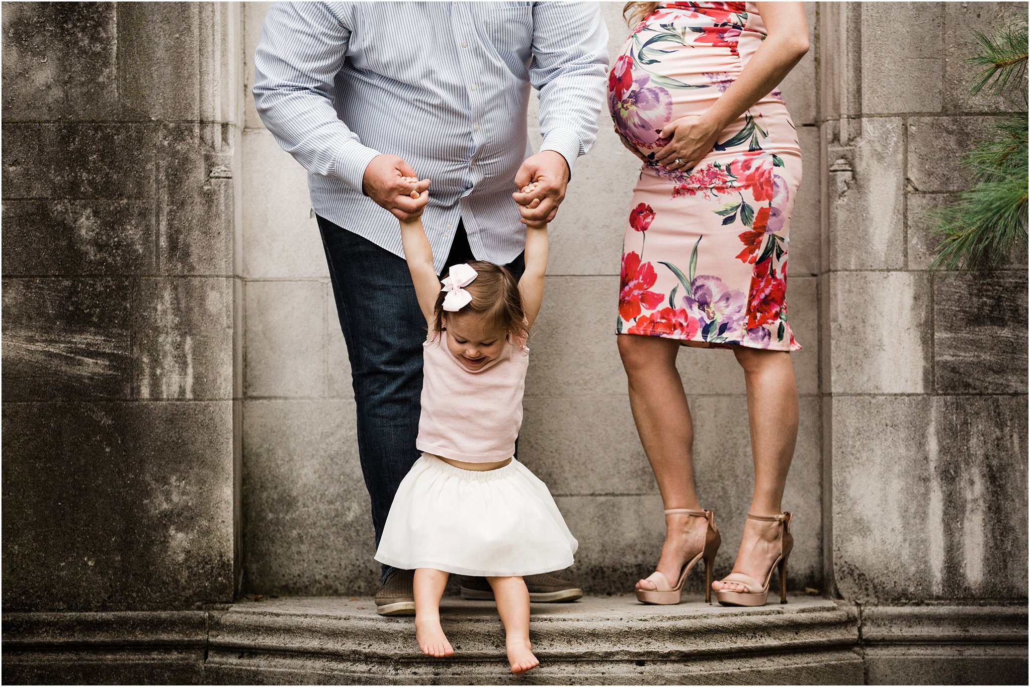 toddler swinging in maternity bump photo