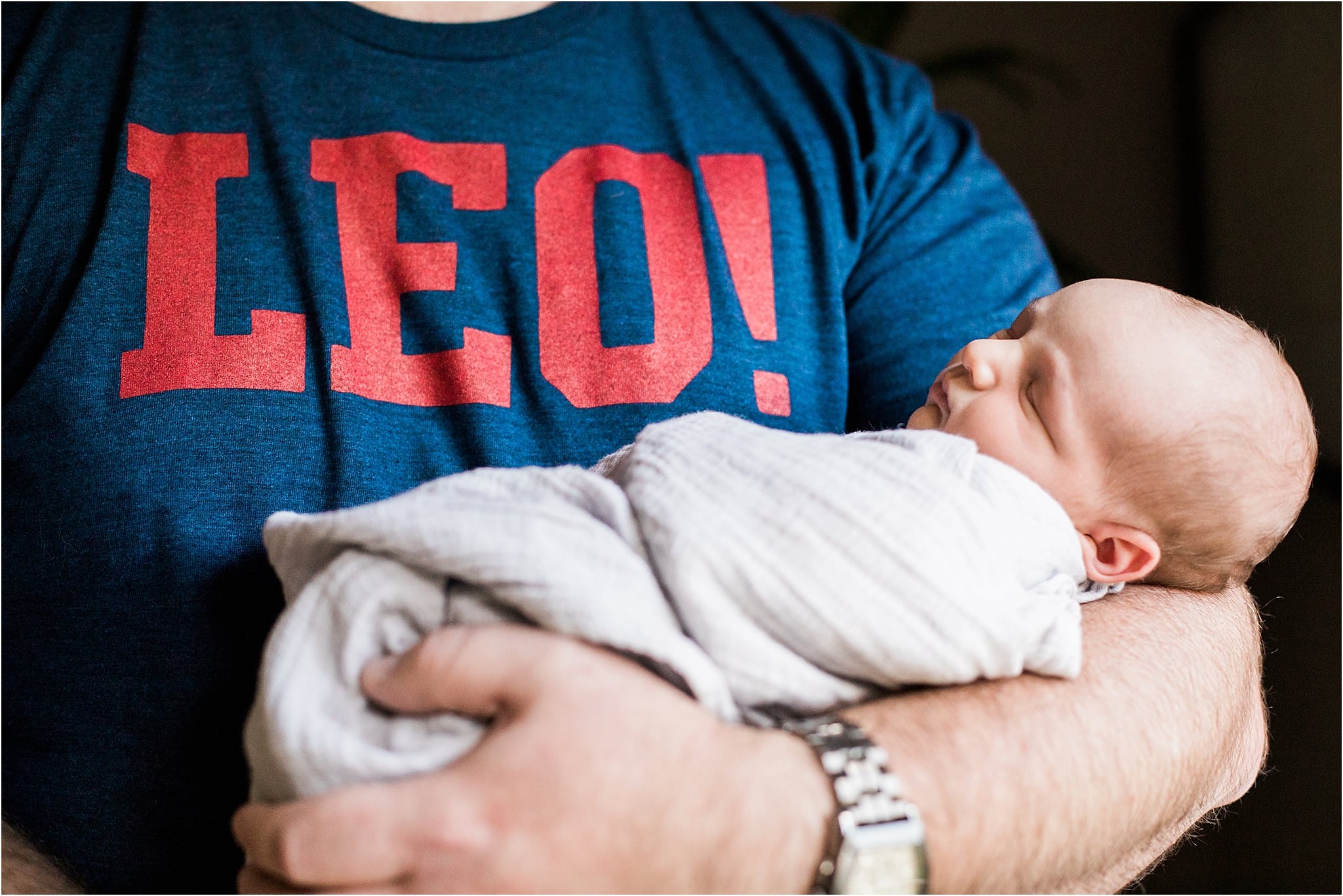 fathers arms holding newborn