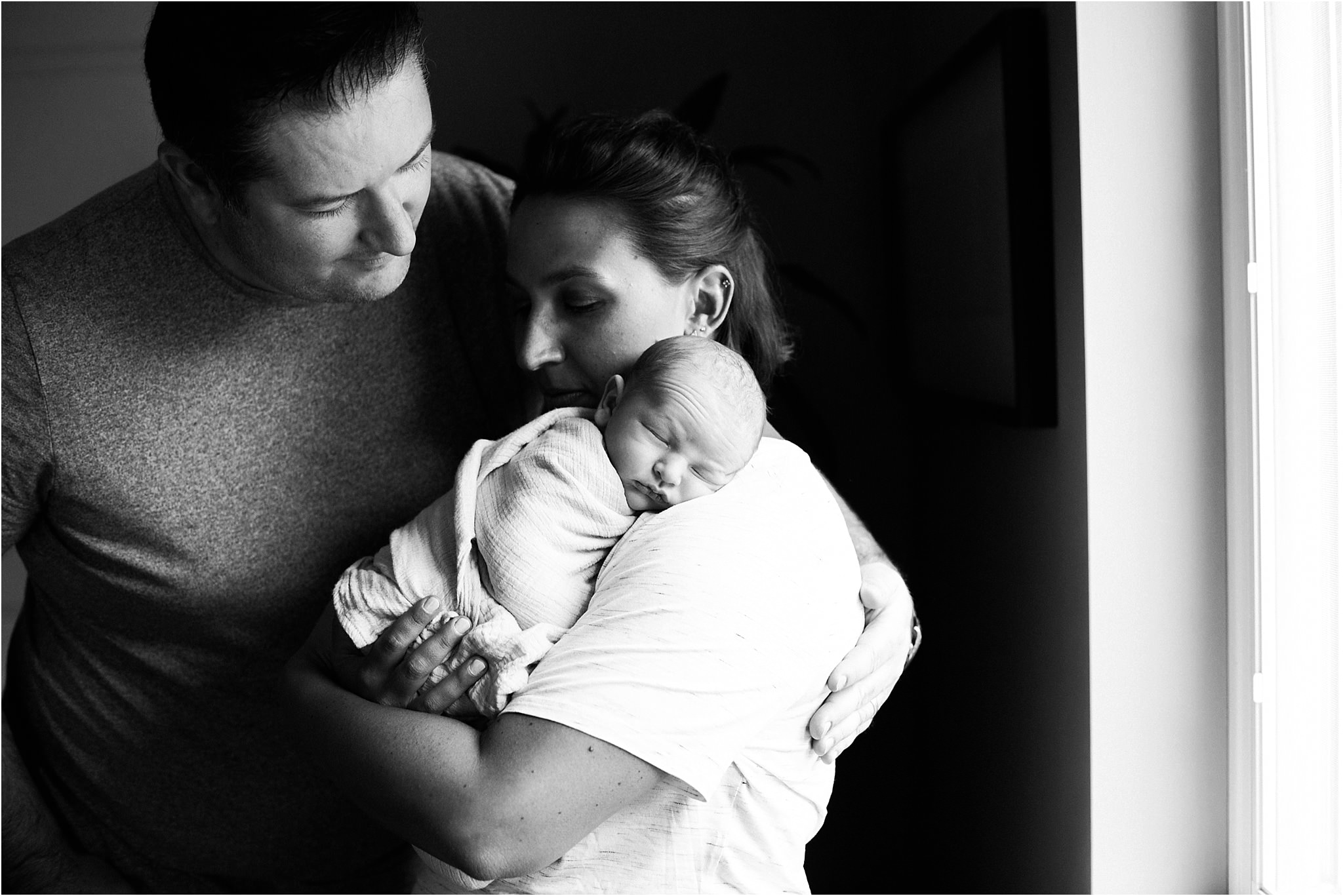 parents holding newborn baby boy