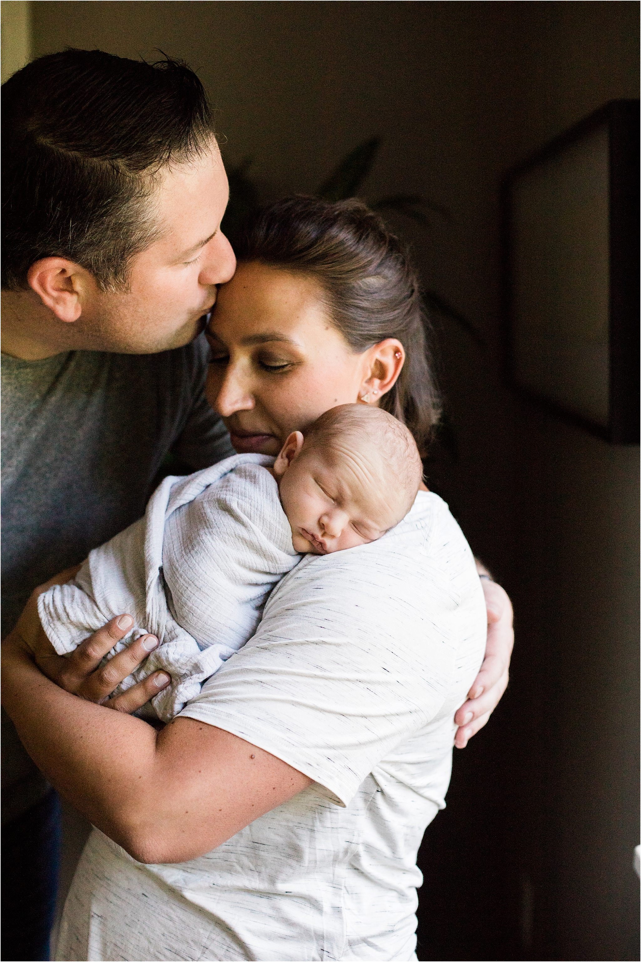 parents holding newborn baby boy