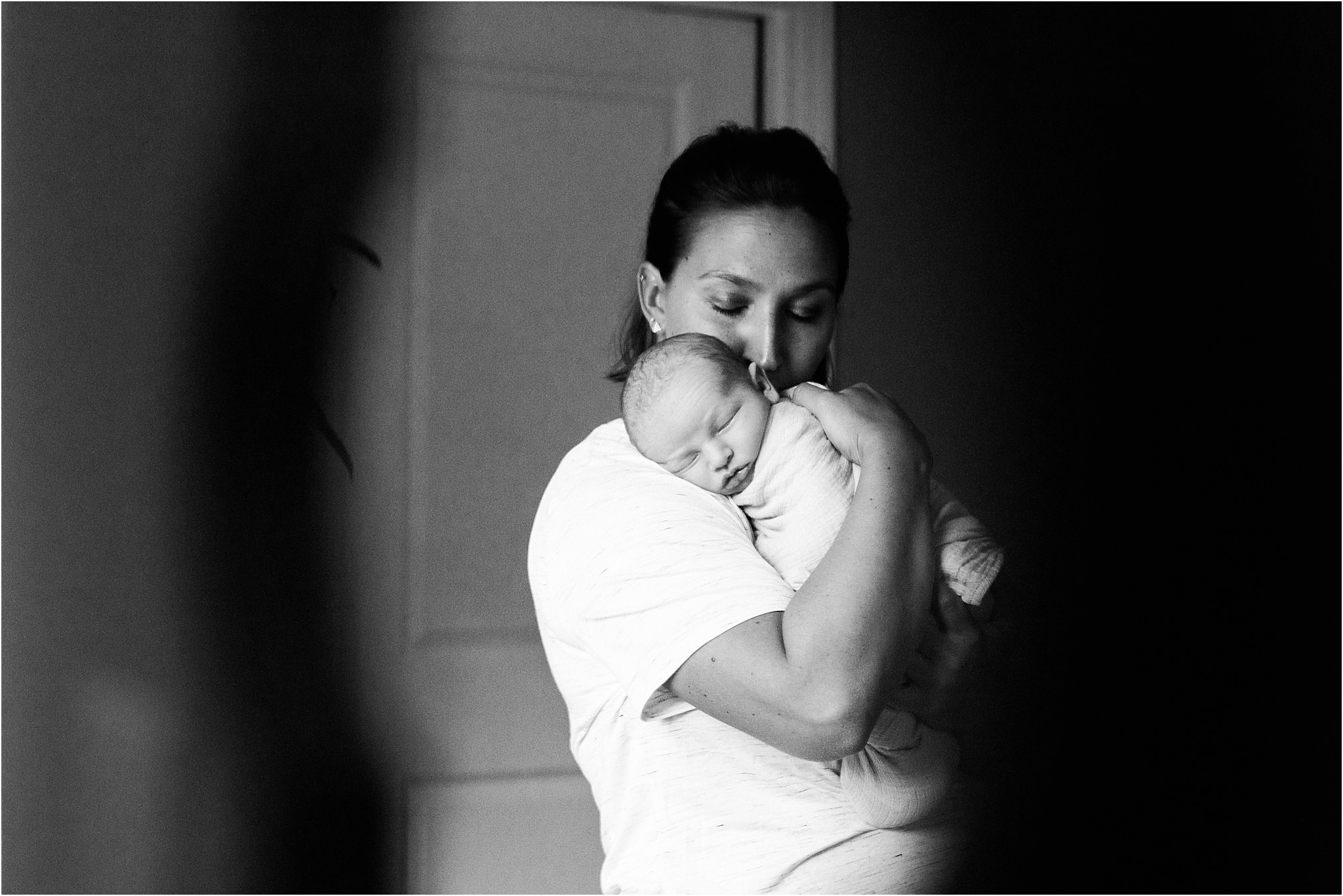 reflection of mother holding newborn baby