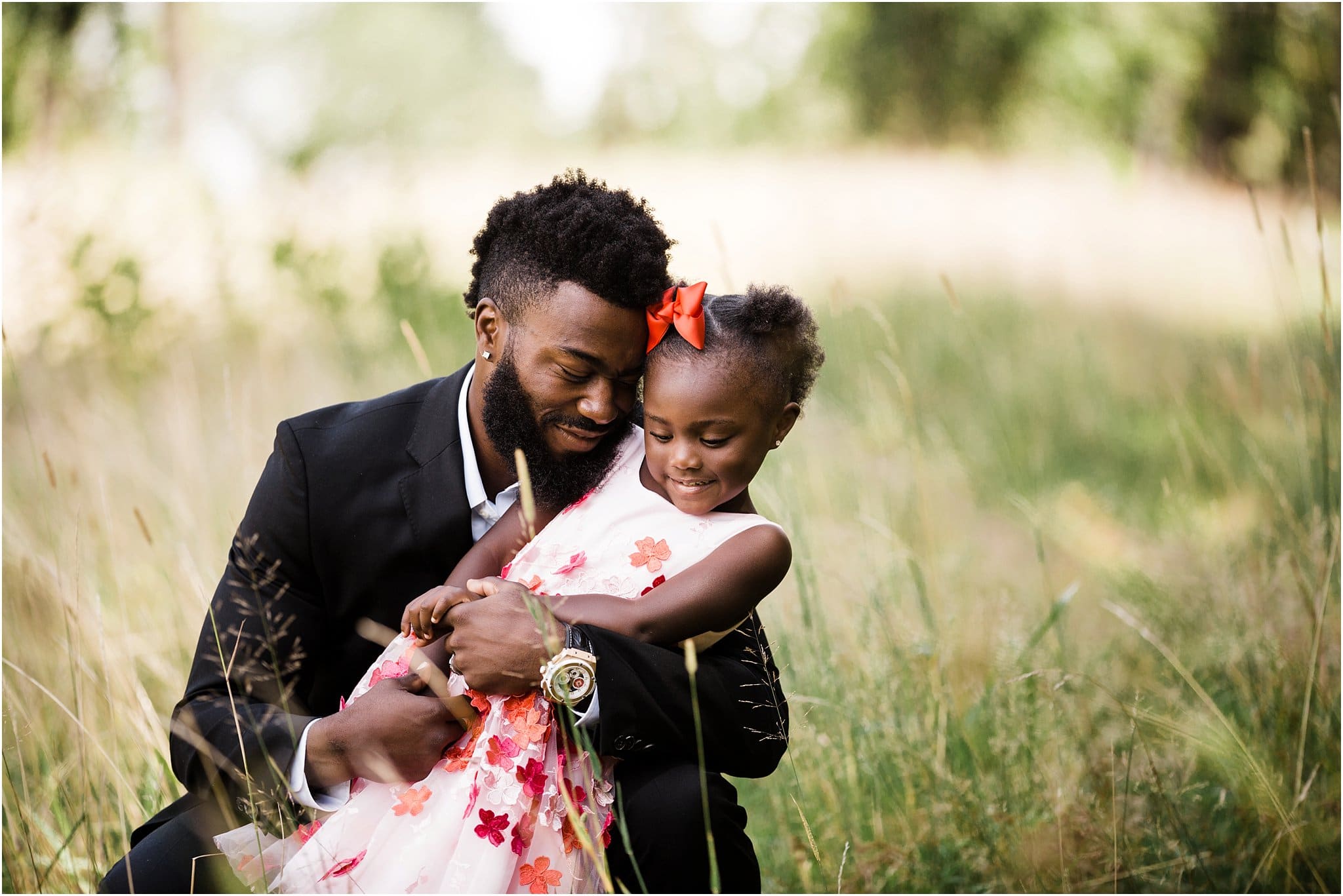 glam daddy and daughter maternity photos with red dresses