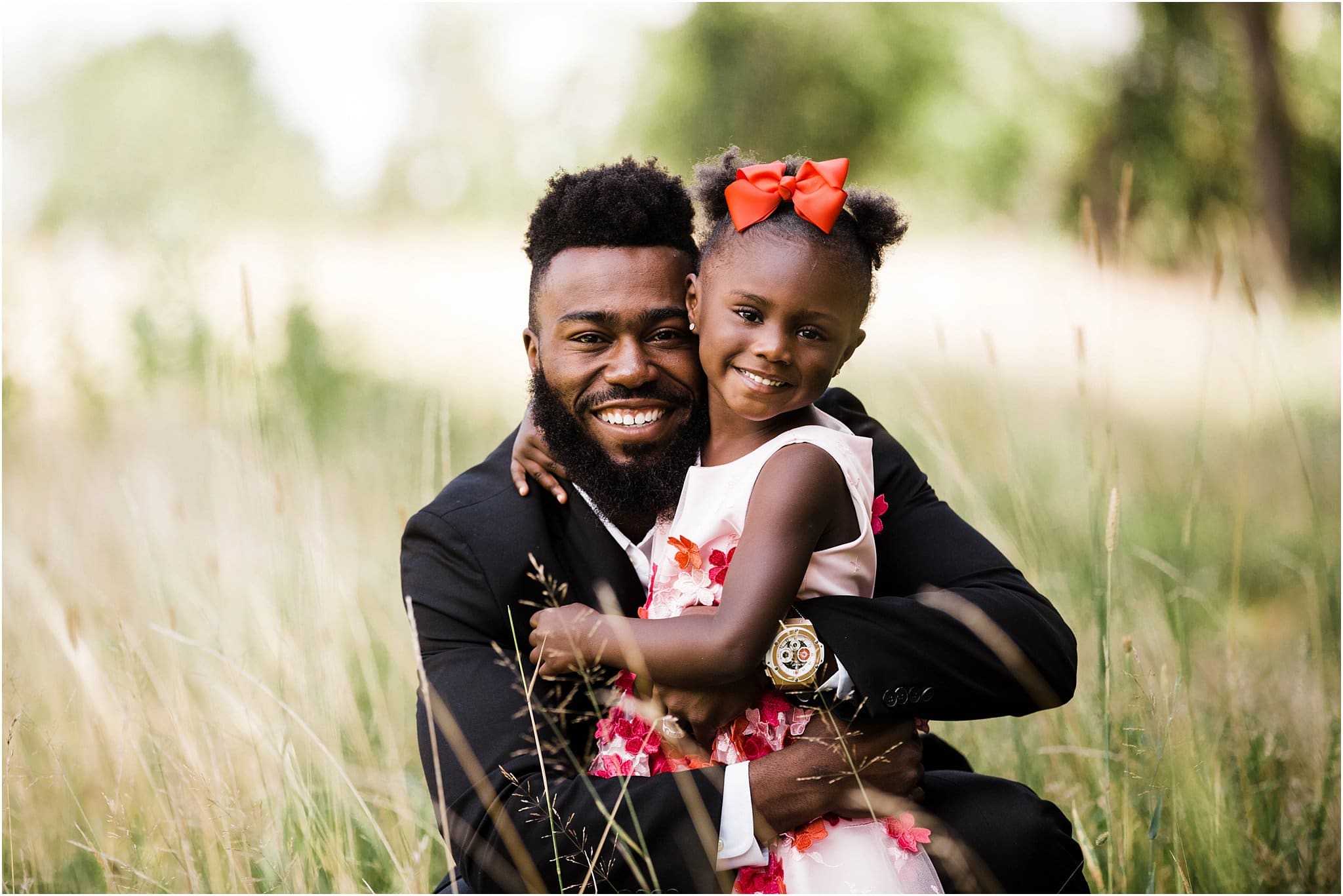 glam daddy and daughter maternity photos with red dresses