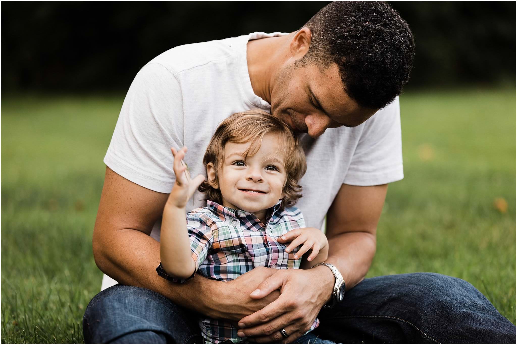 fathers arms wrapped around toddler boy 