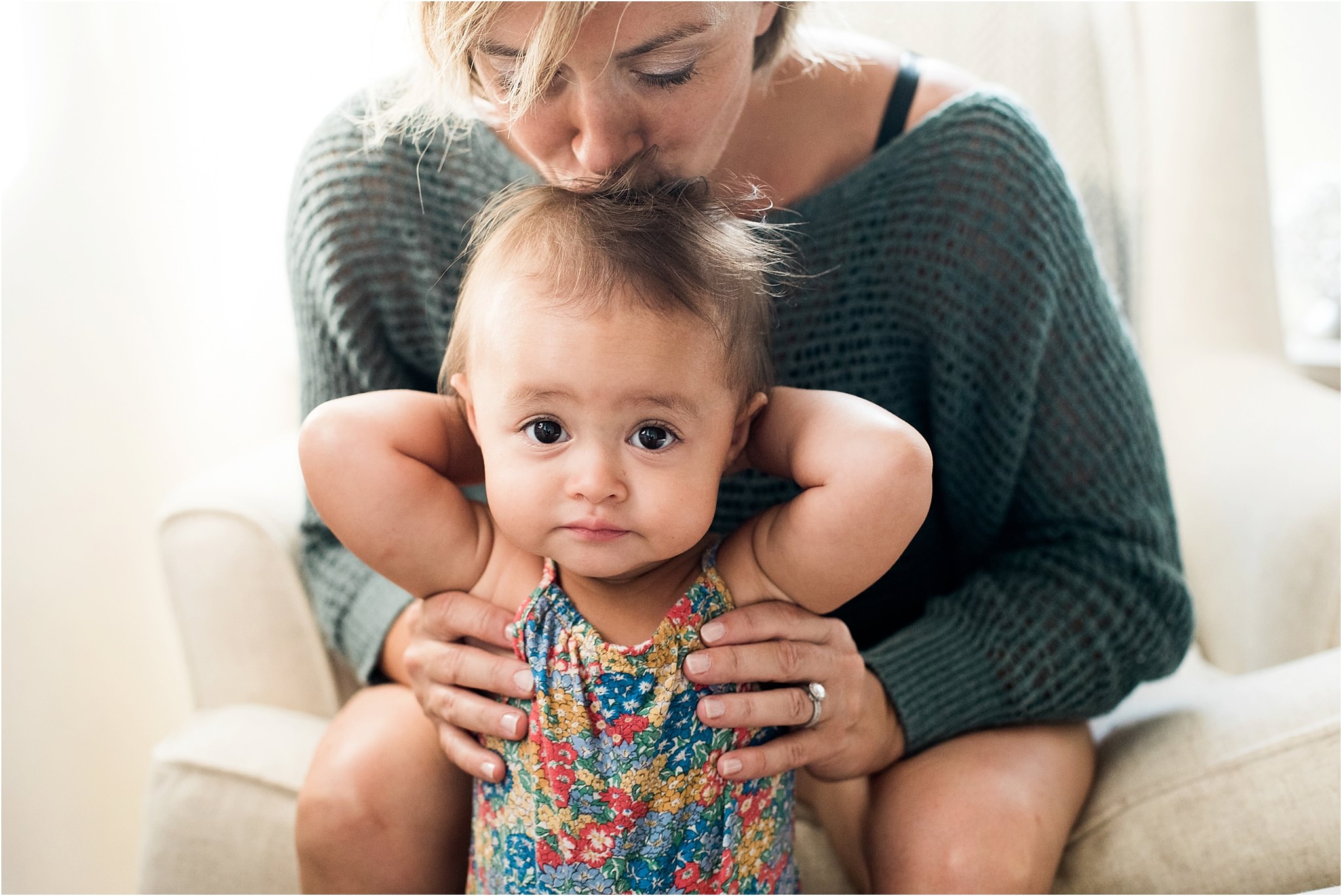 mother kissing beautiful baby girl on the head