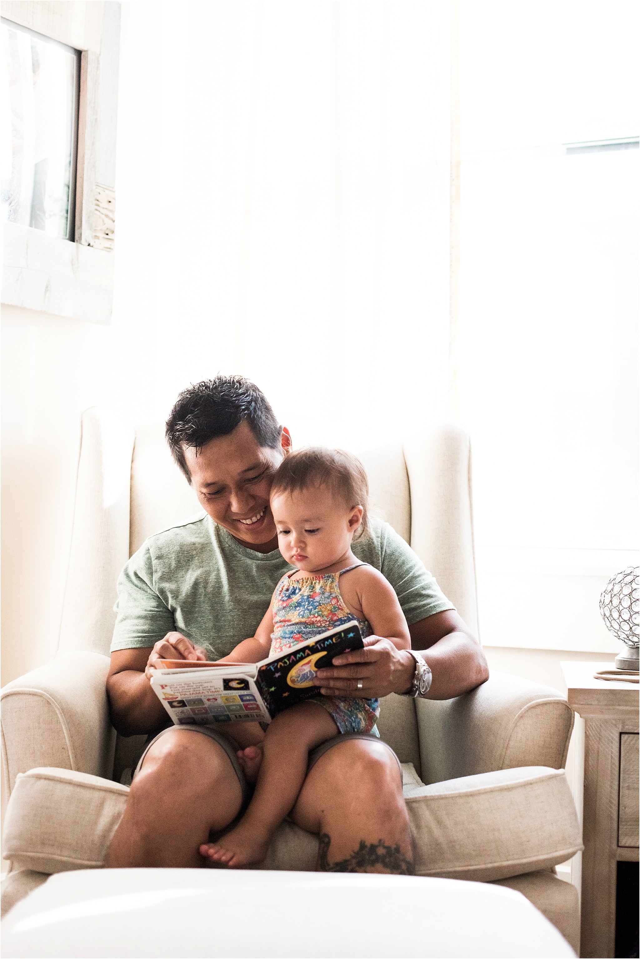 father reading a book to baby girl