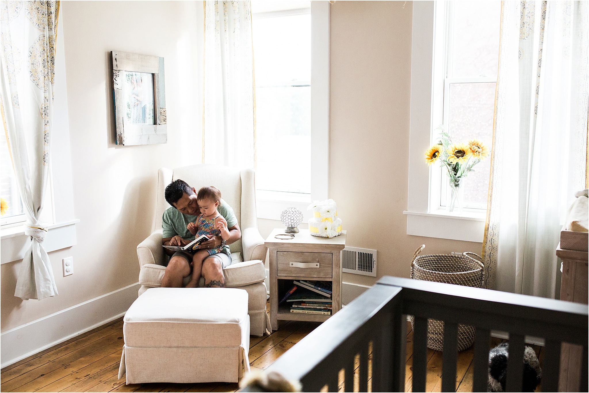 father reading a book to baby girl