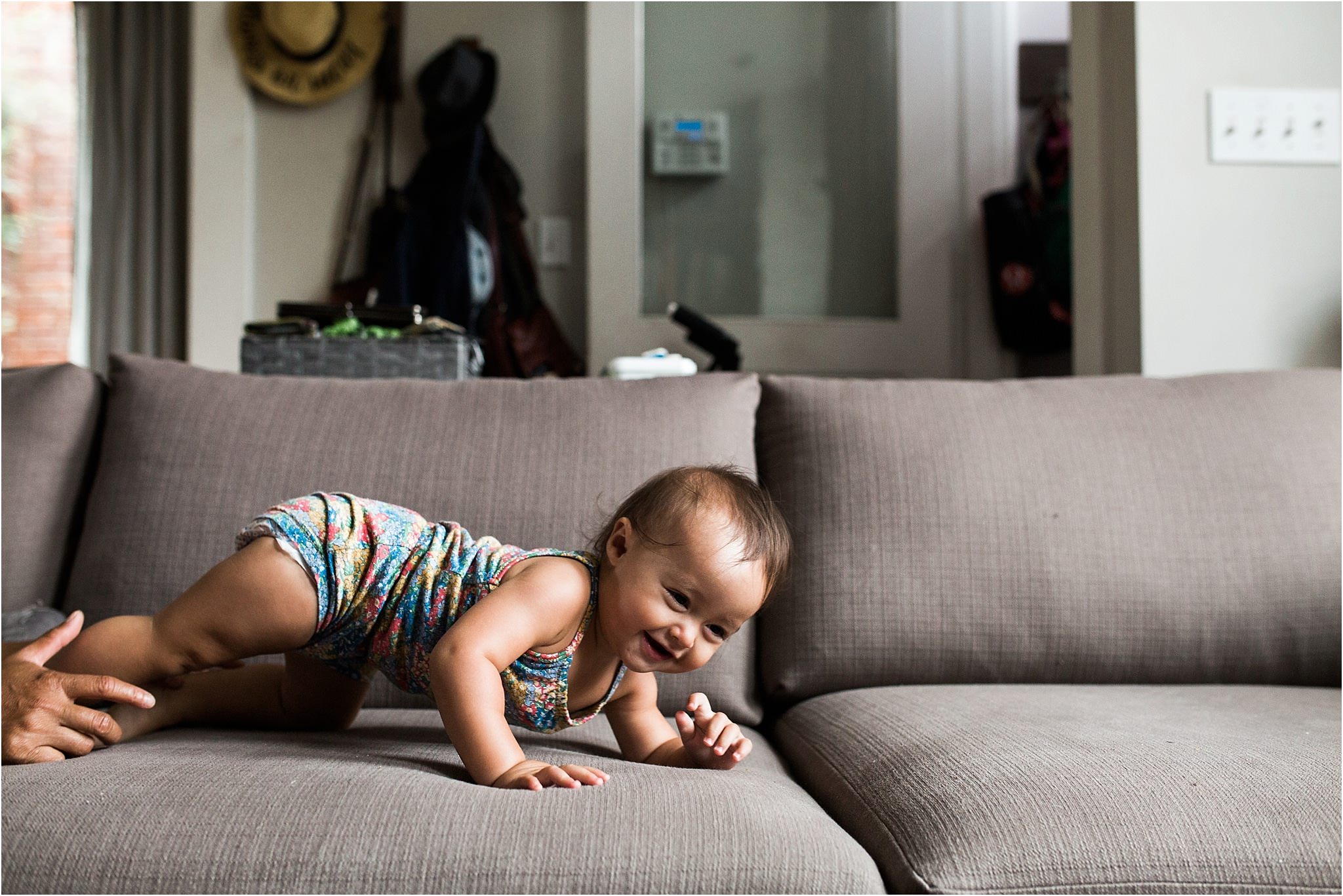 baby girl crawling away from dad on the couch