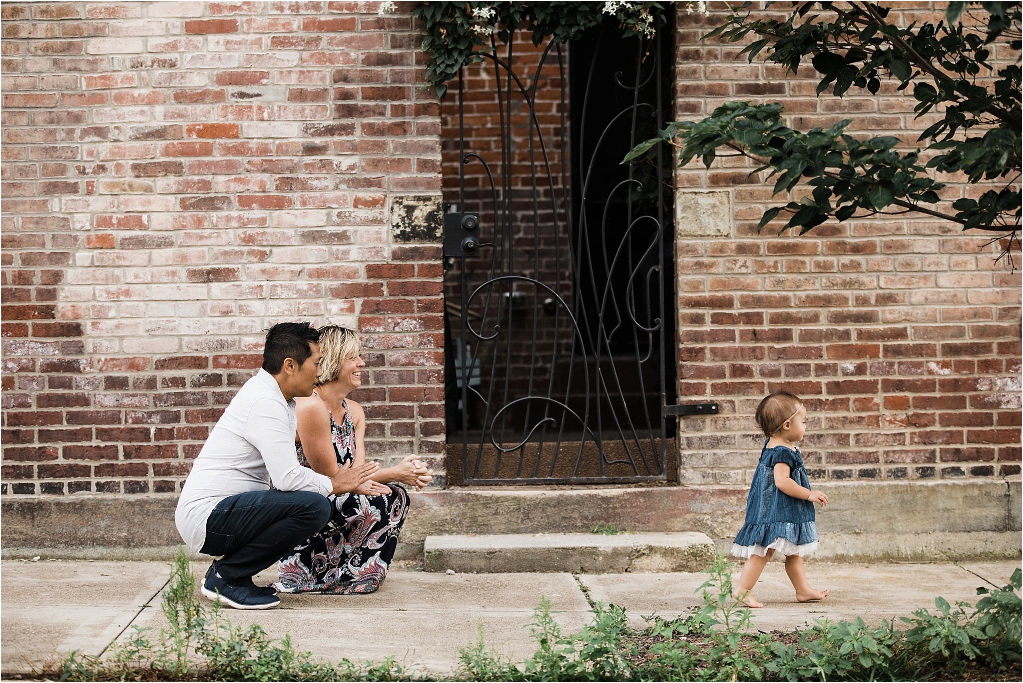 one year old girl walking away from parents