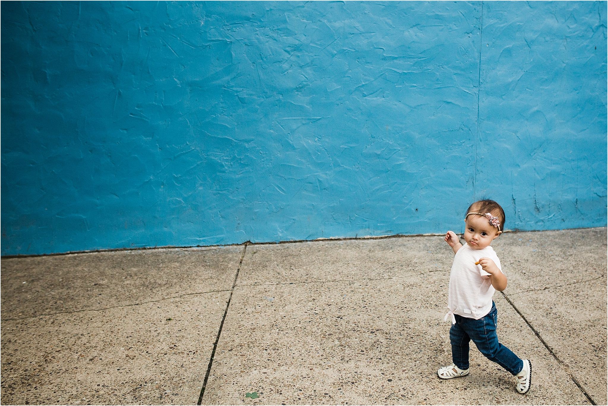 one year old girl walking in her lawrenceville neighborhood