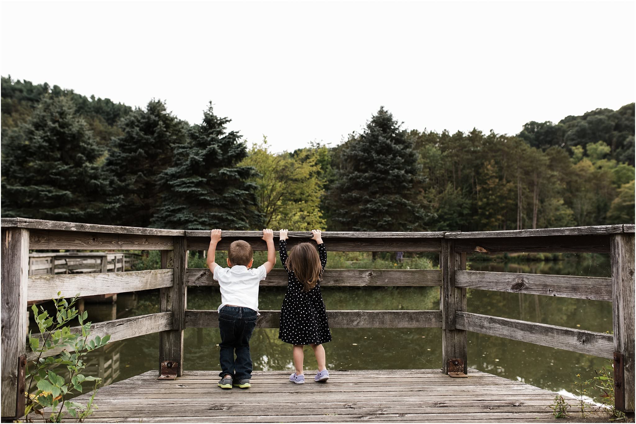 brother and sister staring out at north park lake