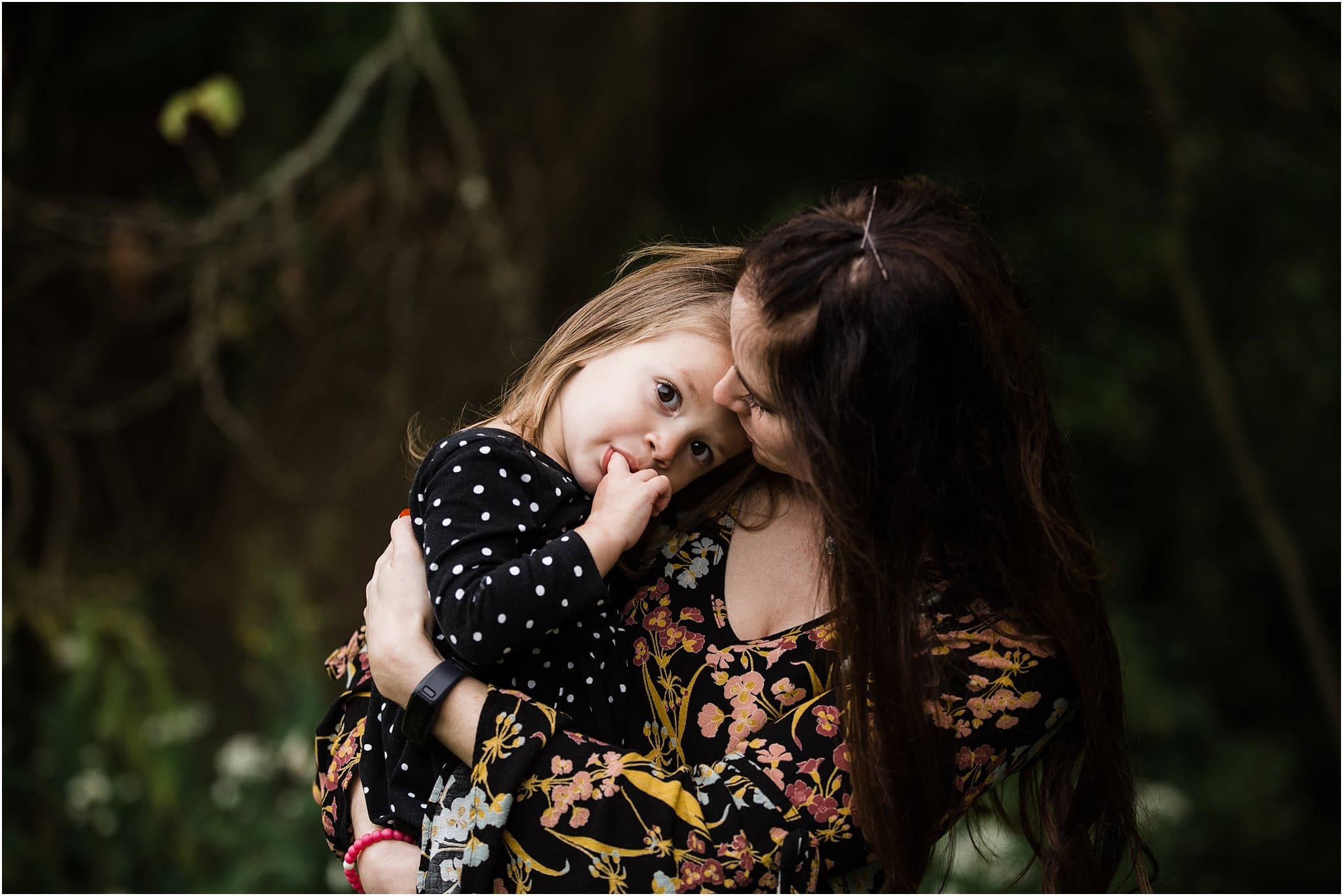 daughter resting in mothers arms