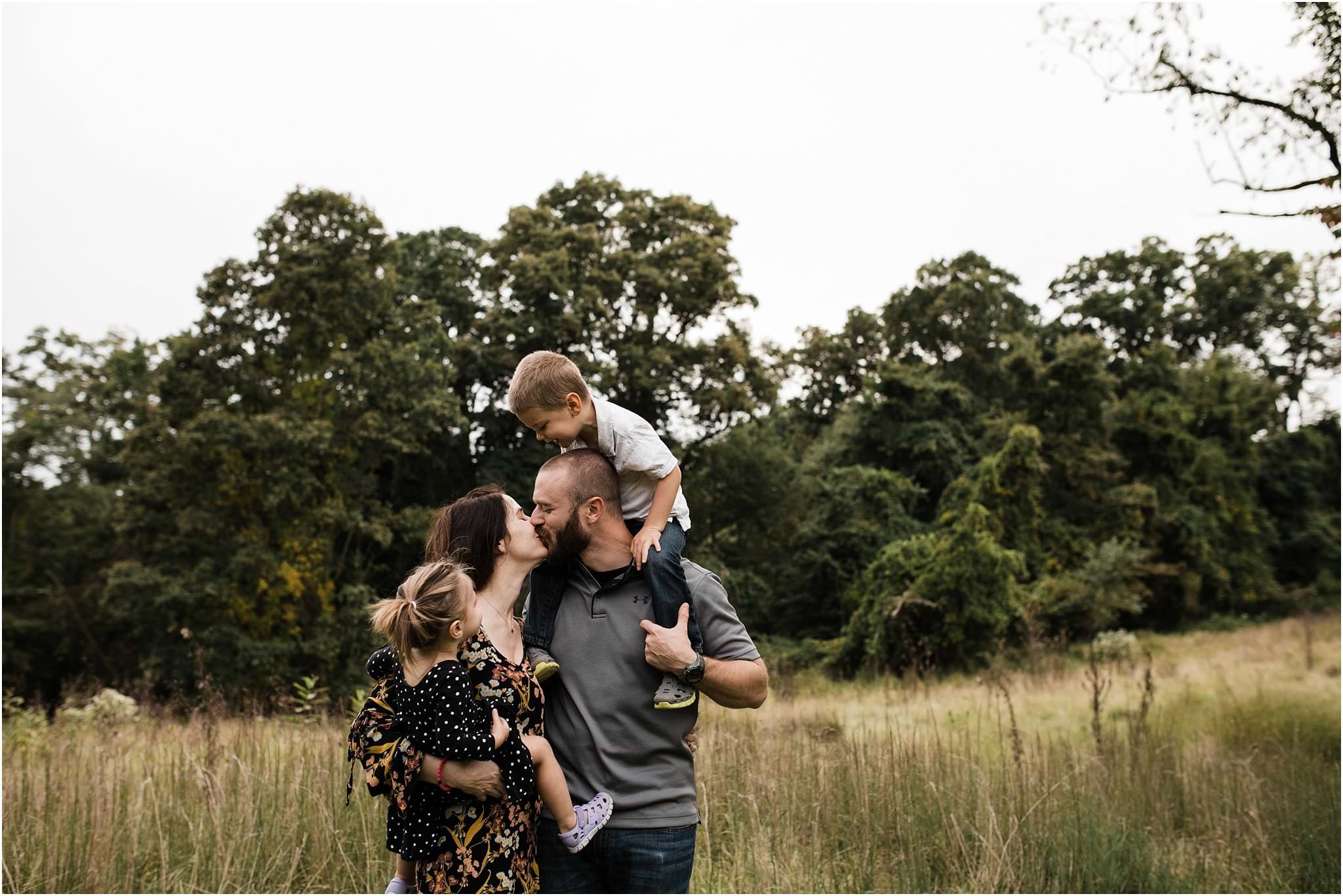 children watching mother and father kiss