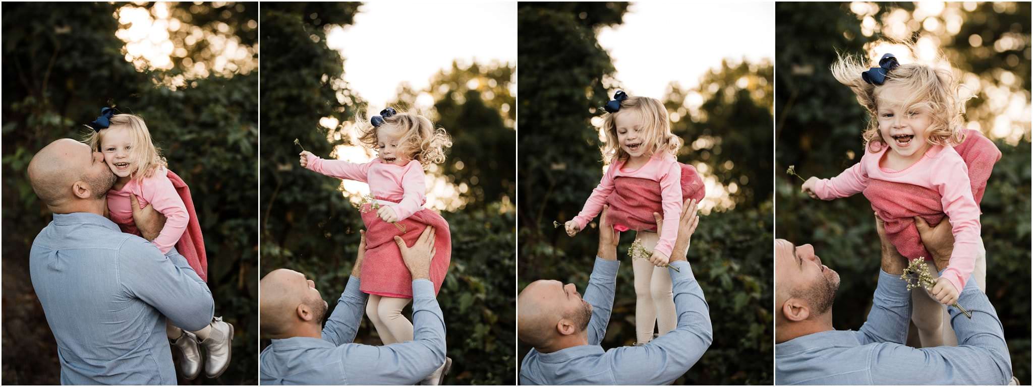 Dad tossing daughter in the air and laughing