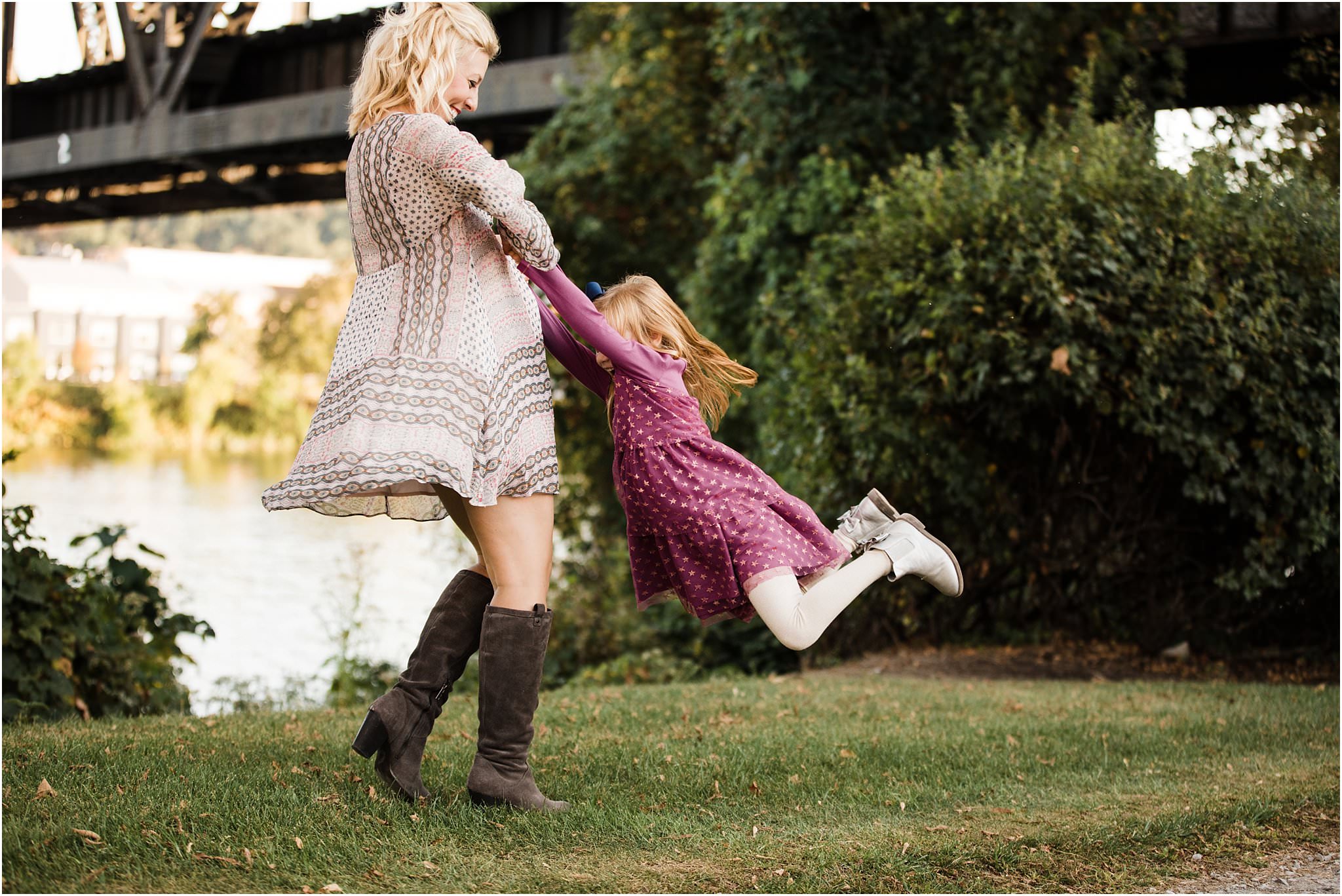 mother swinging daughter in the air