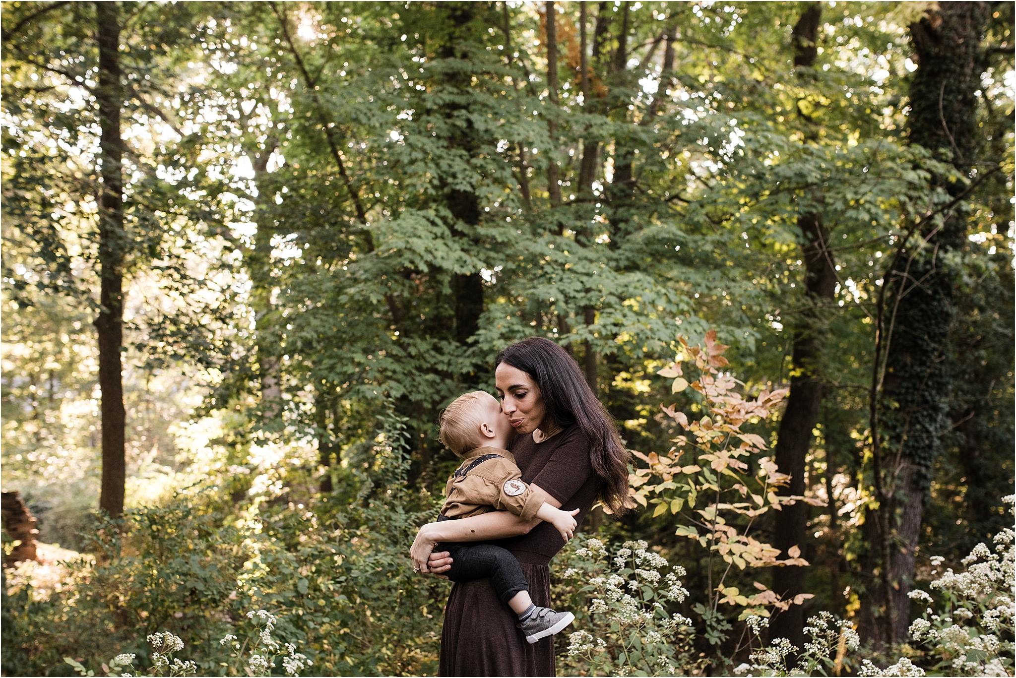 mother snuggling toddler boy