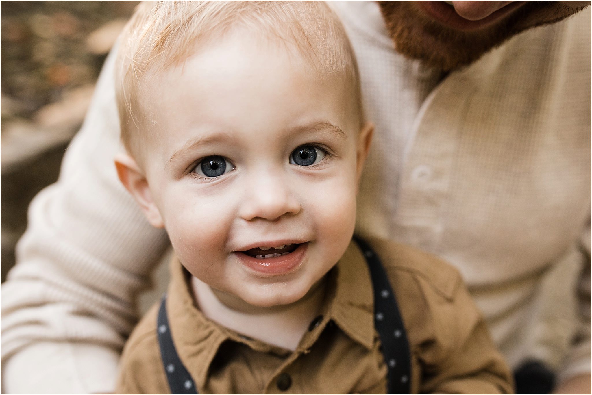 photo of one year old boy in fathers lap