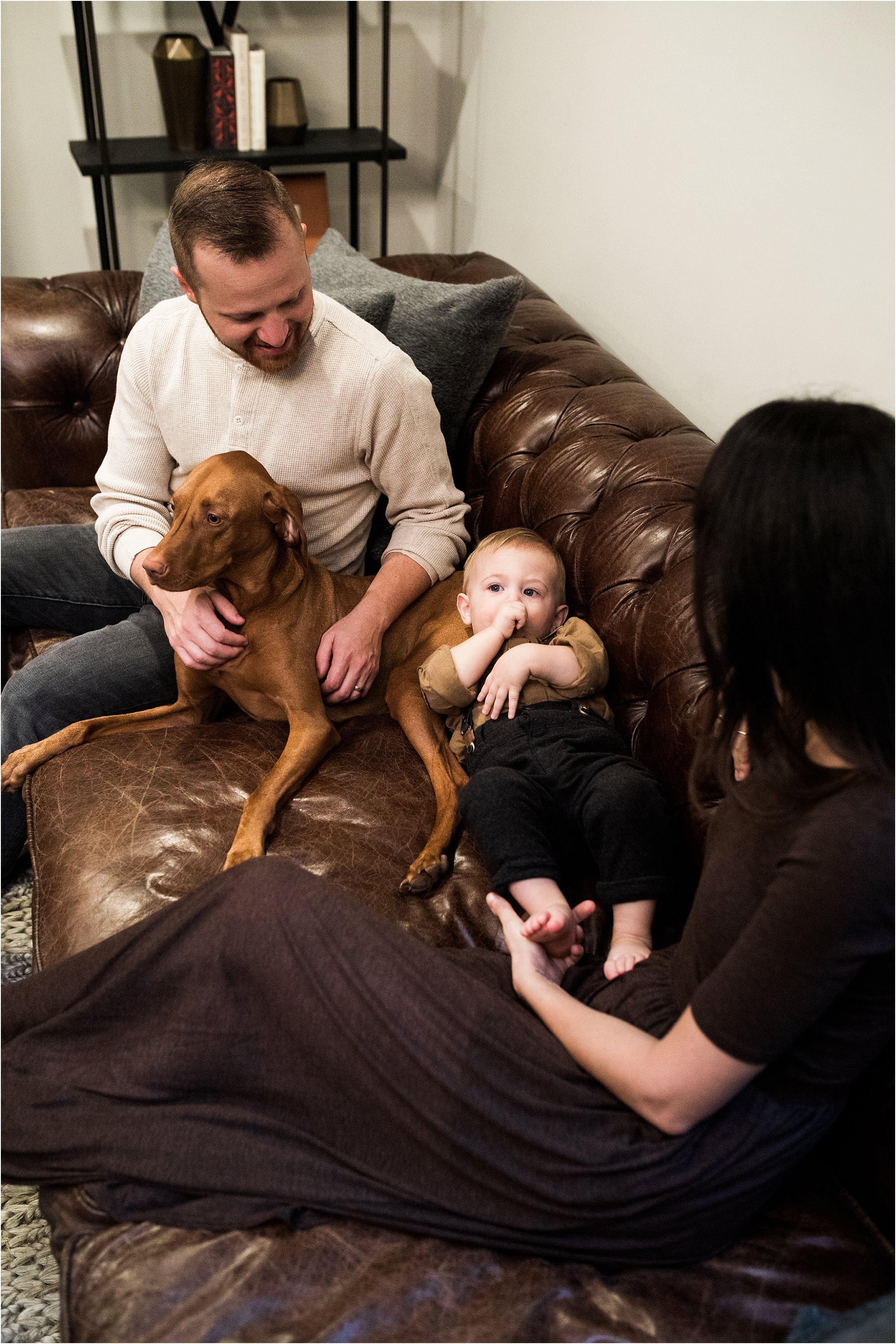 family snuggled up on living room couch