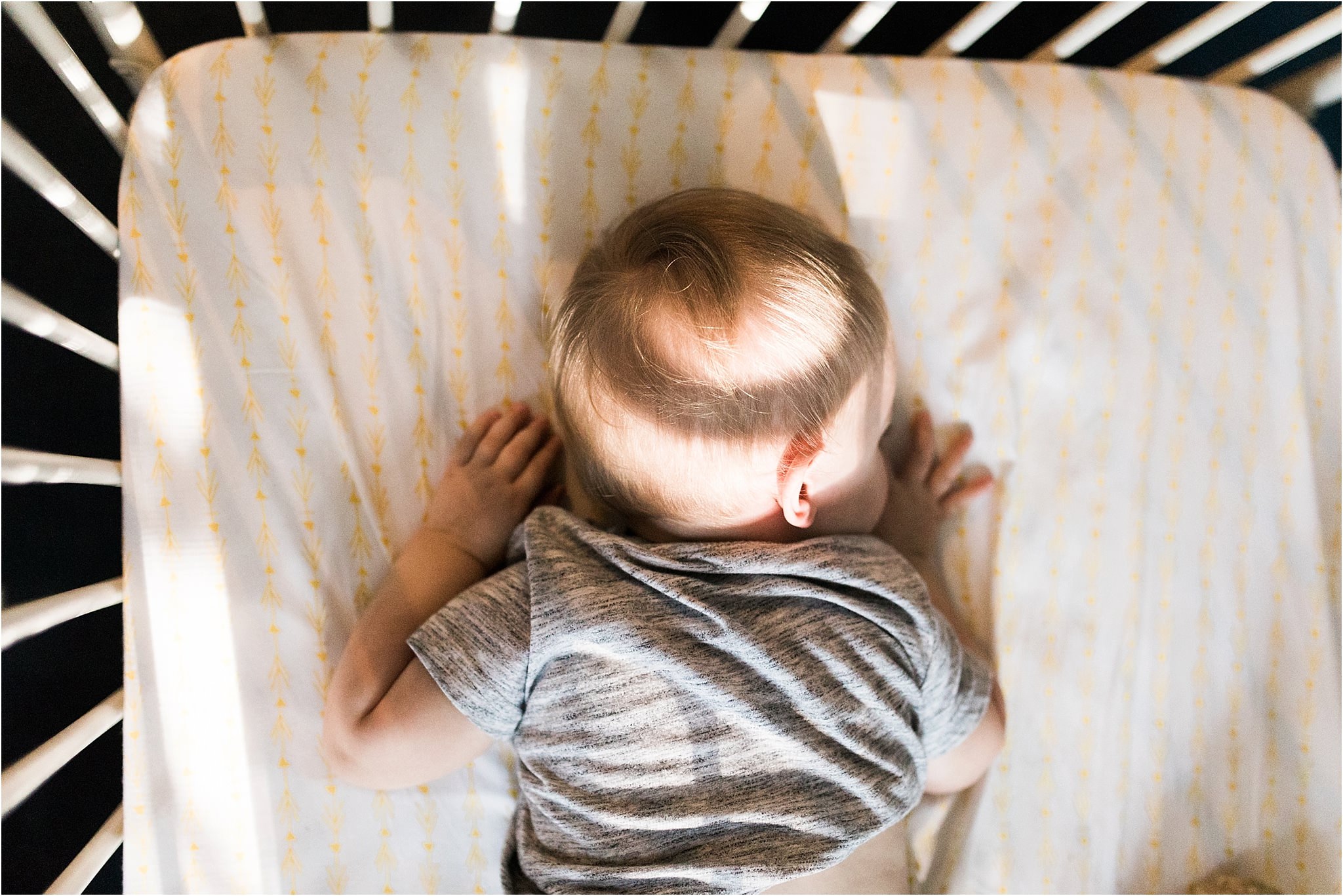 one year old boy sleeping in crib