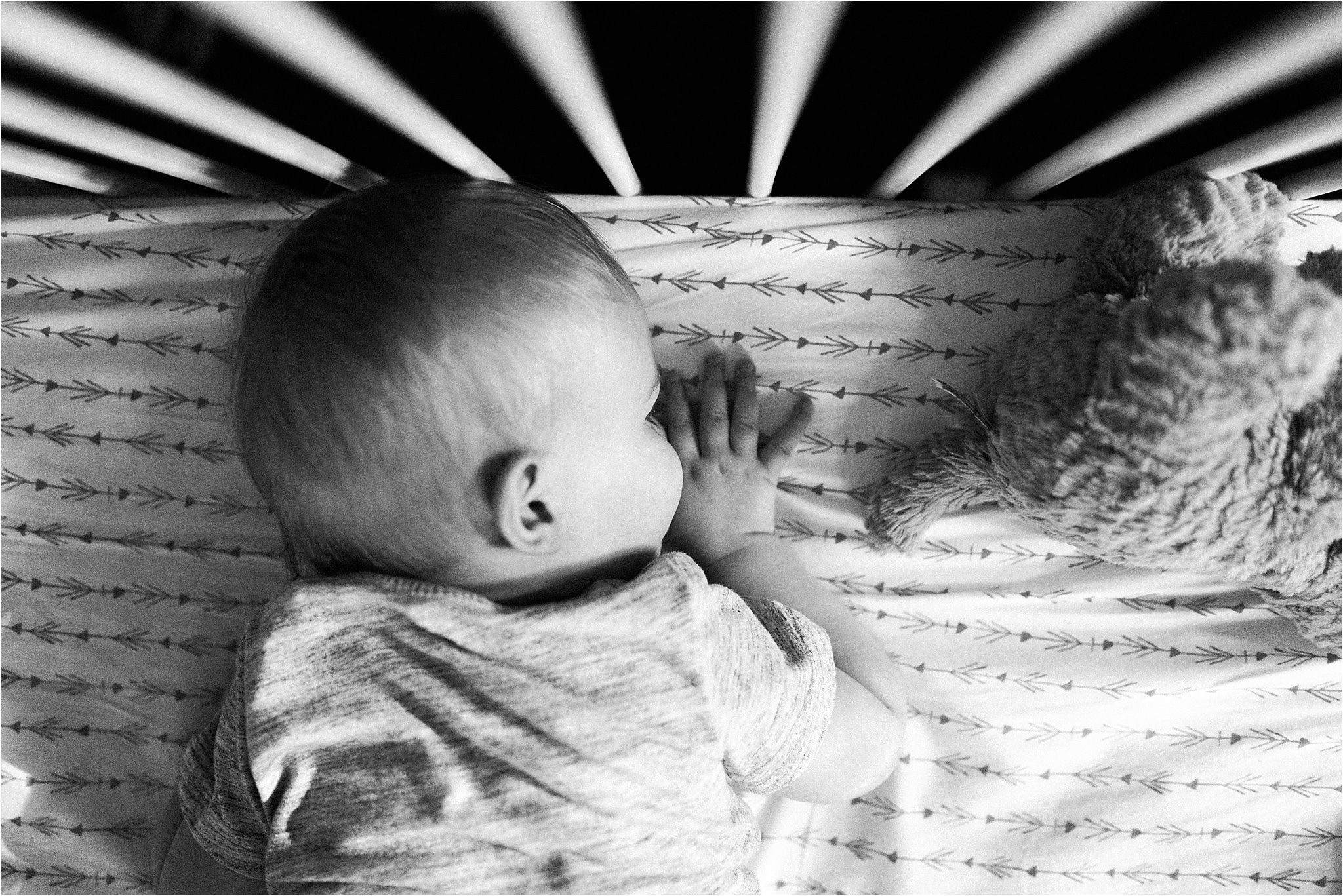 one year old boy sucking thumb in crib