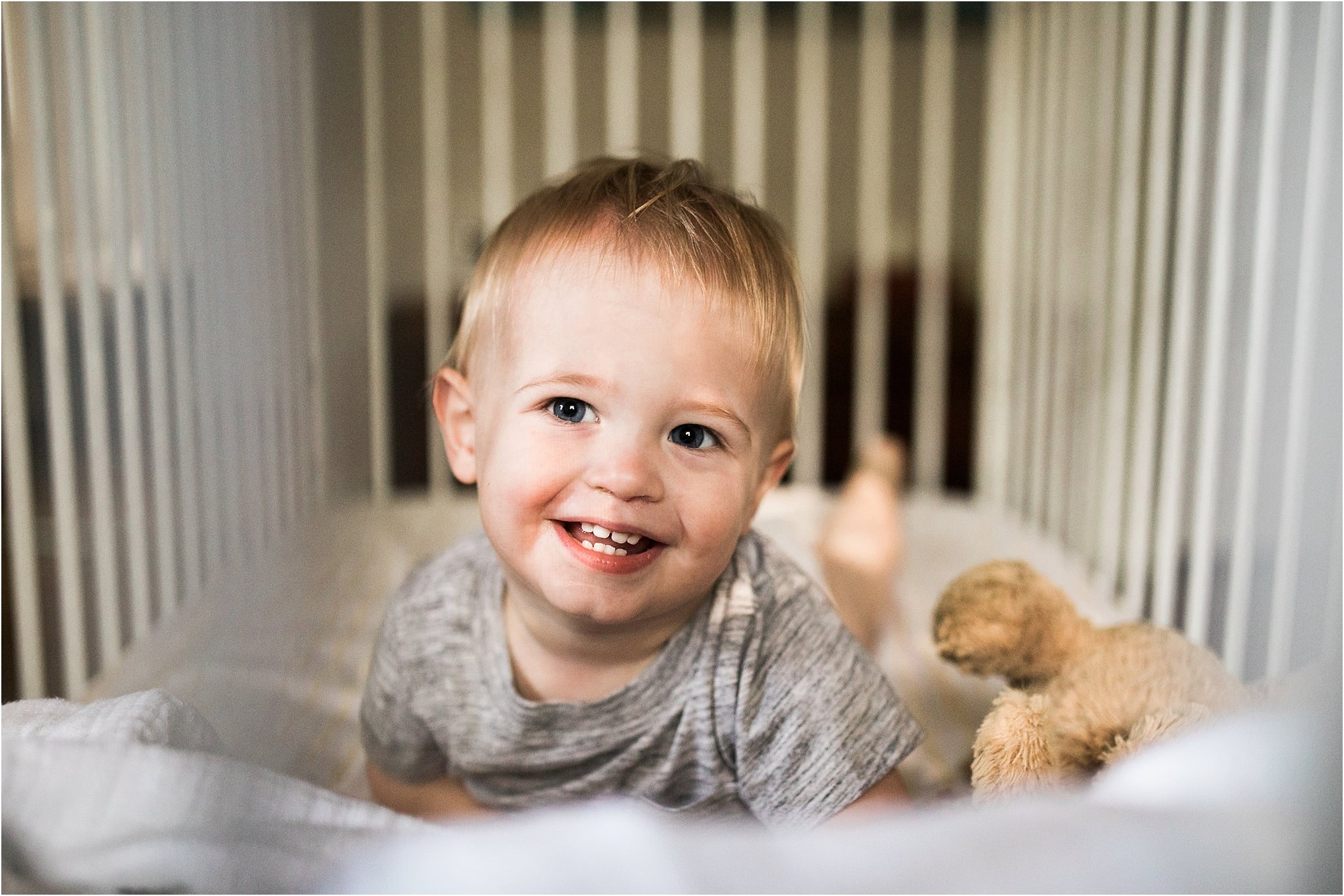 smiling toddler in crib