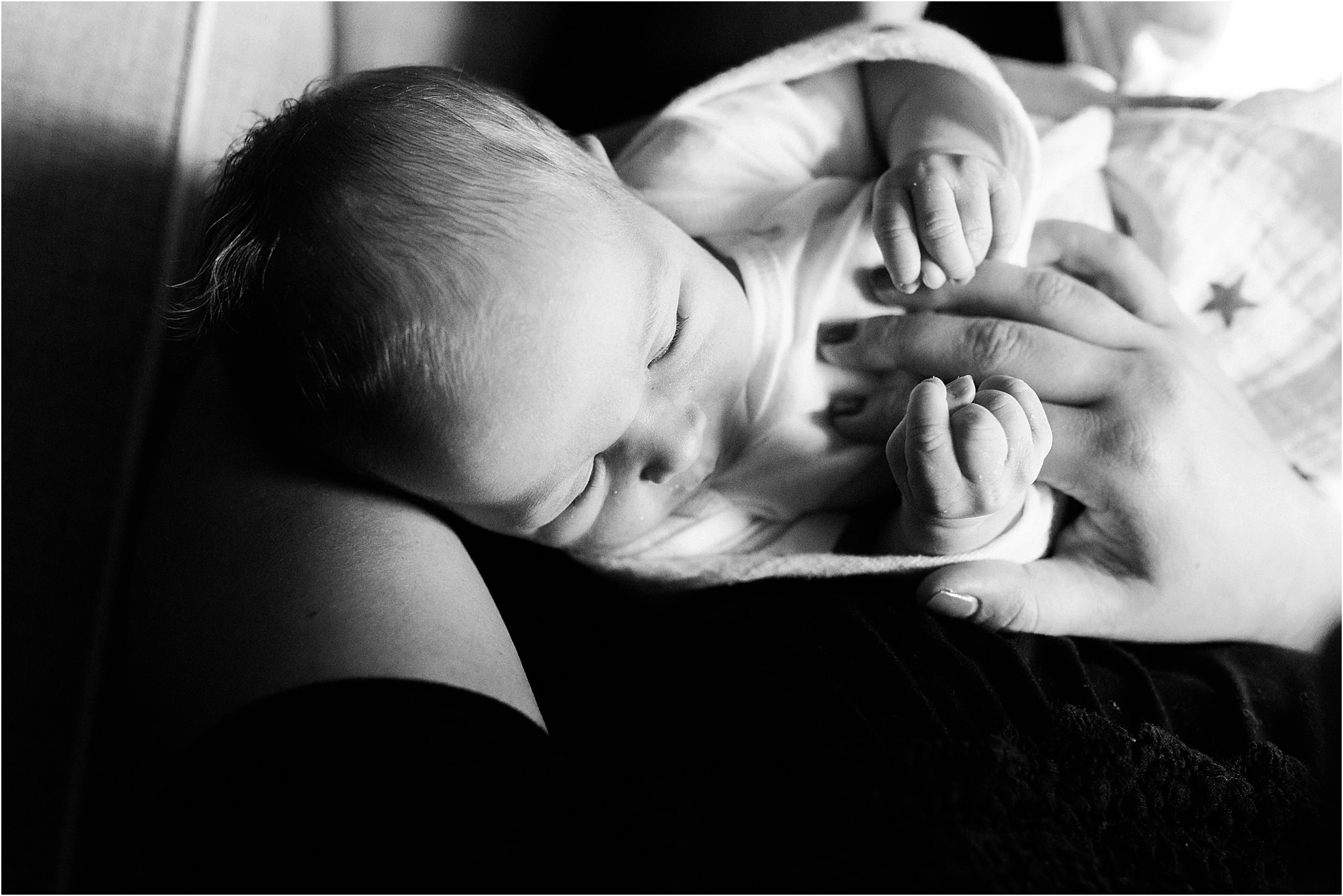 newborn baby holding mothers hand