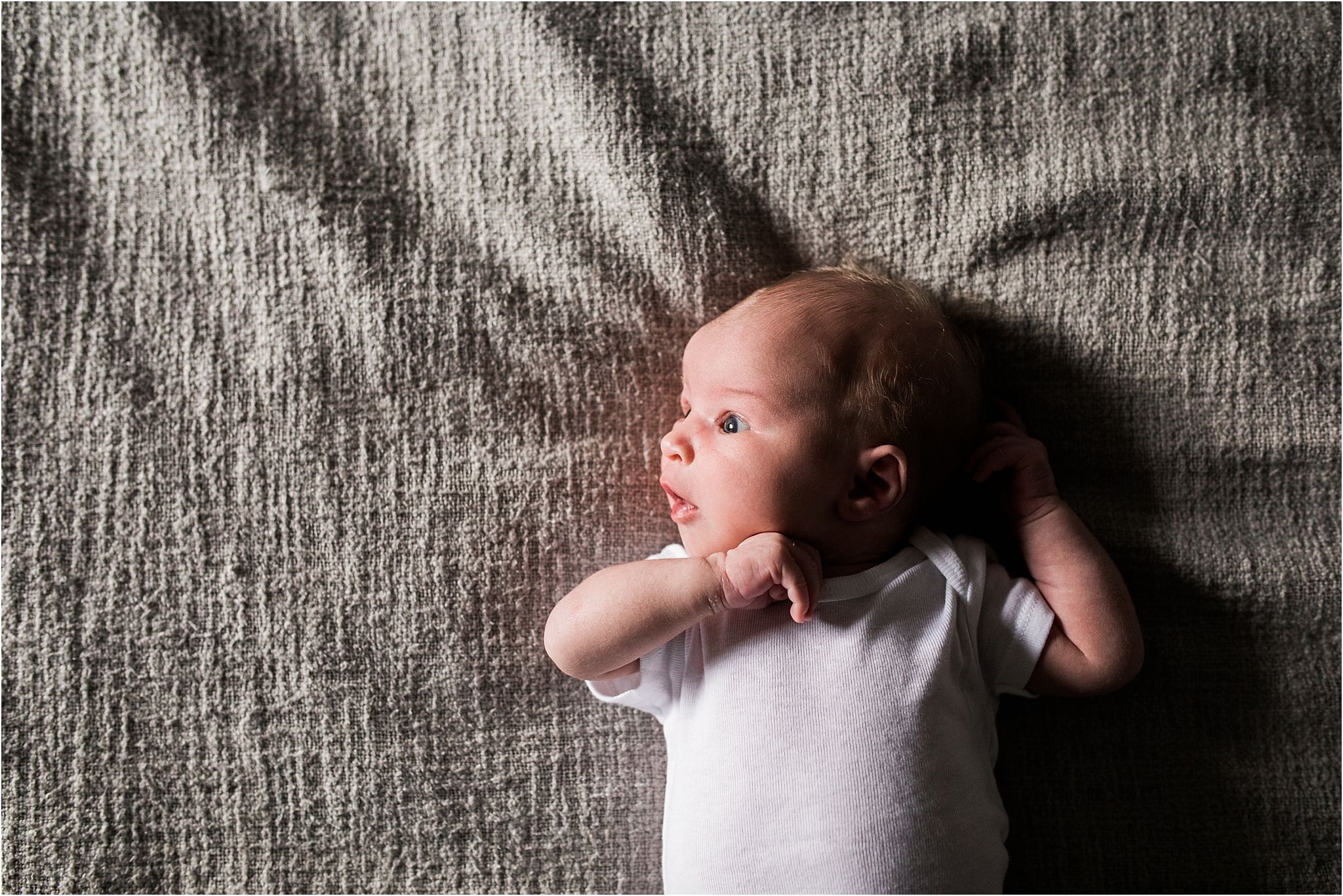 natural photo of newborn baby on bed at home