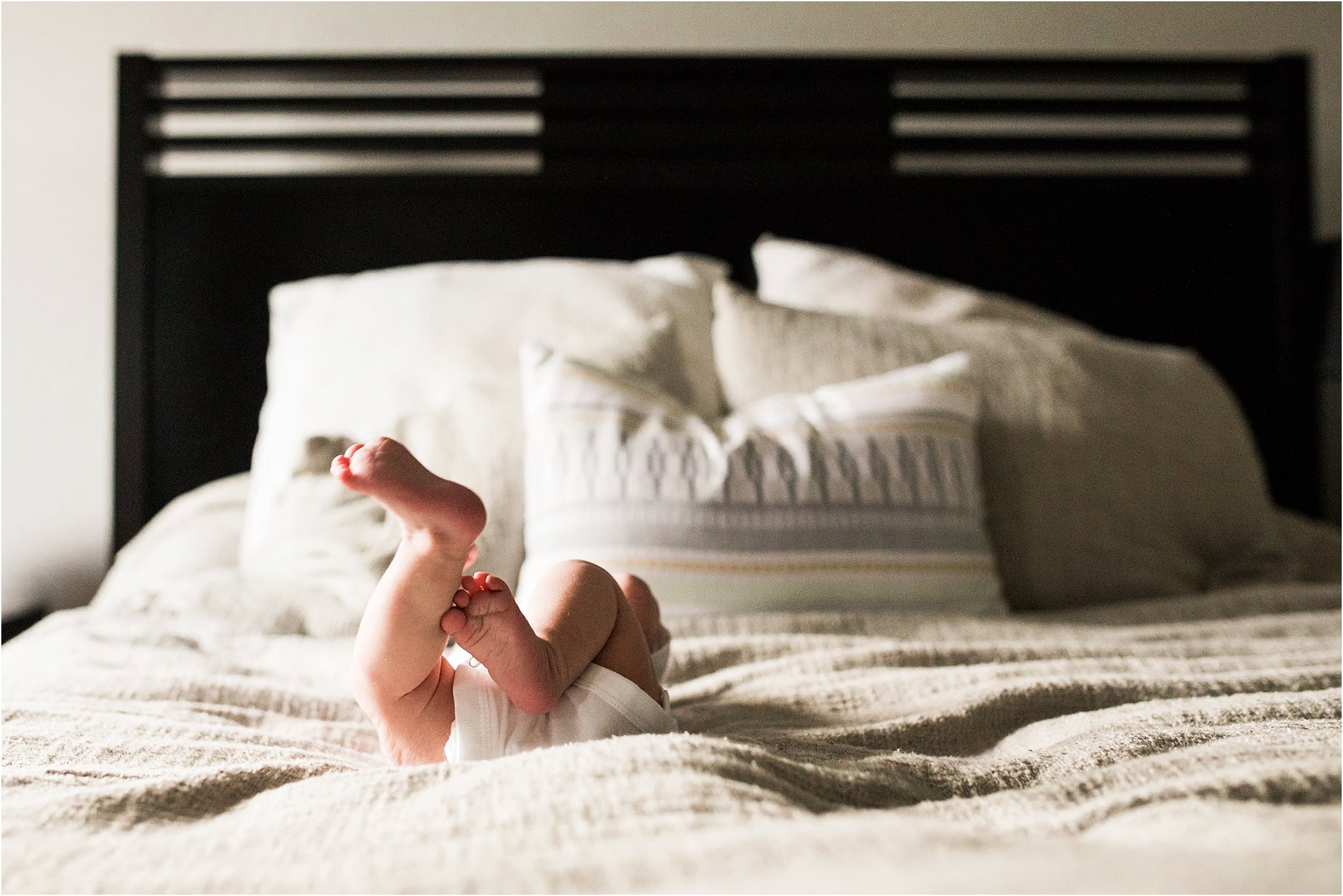 newborn baby feet in the air