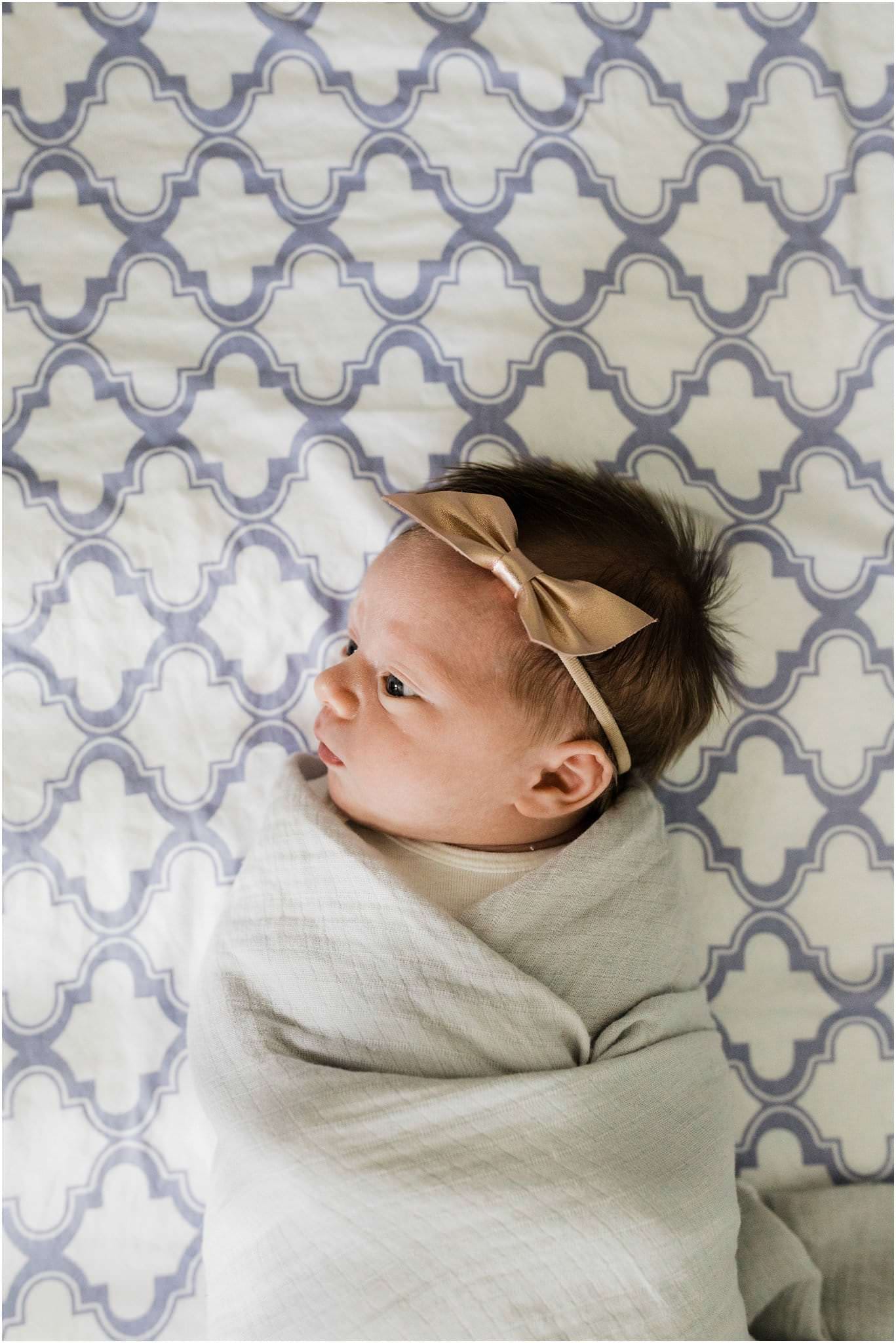 newborn baby girl swaddled in crib