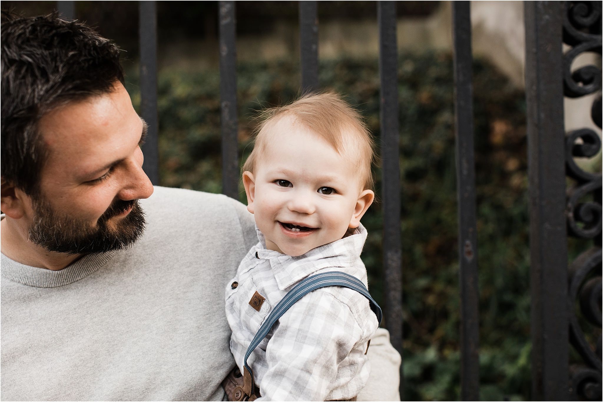 Smiling baby boy in fathers arms